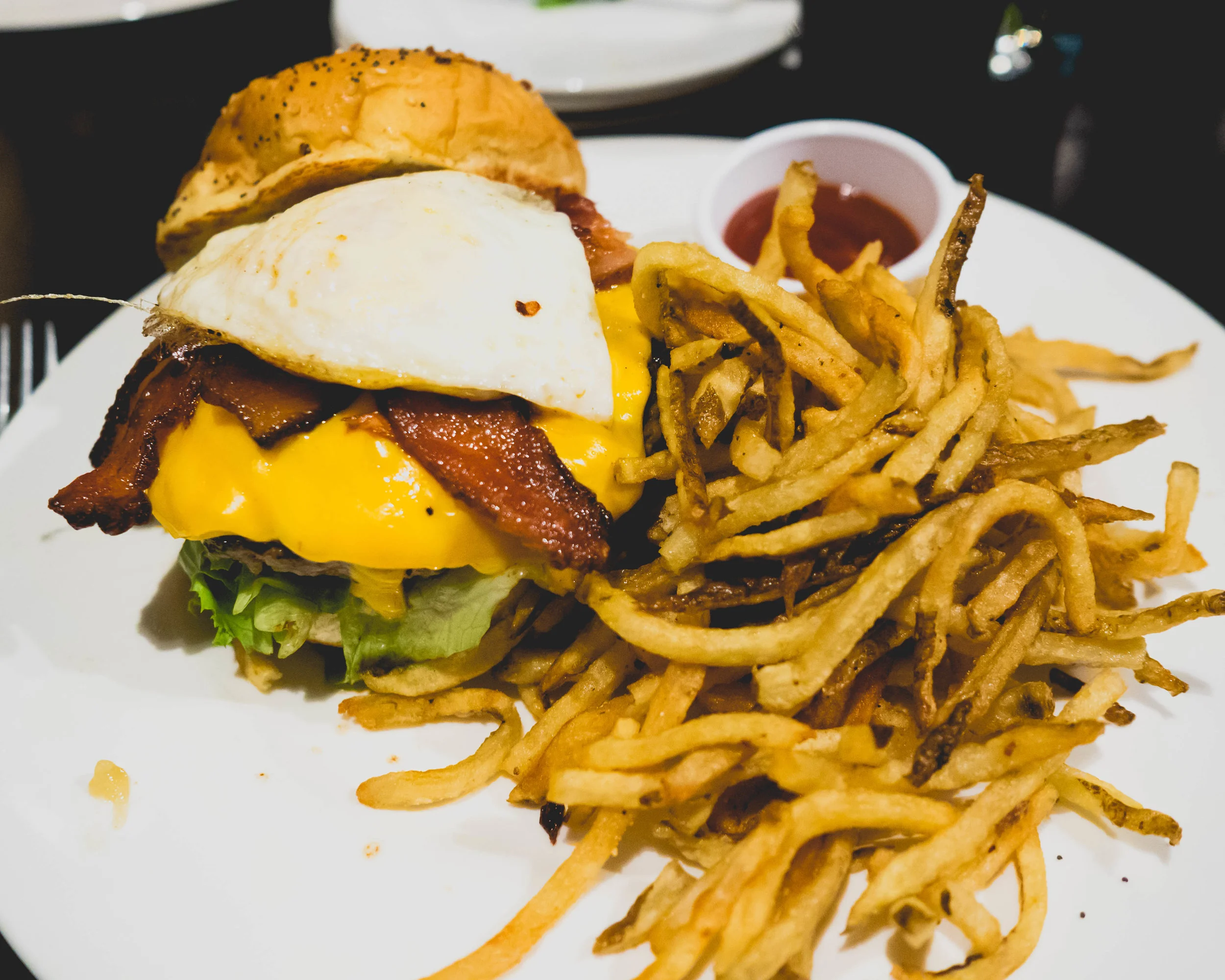 the farmhouse burger : american cheese, fried egg, smoked bacon, garlic aioli.