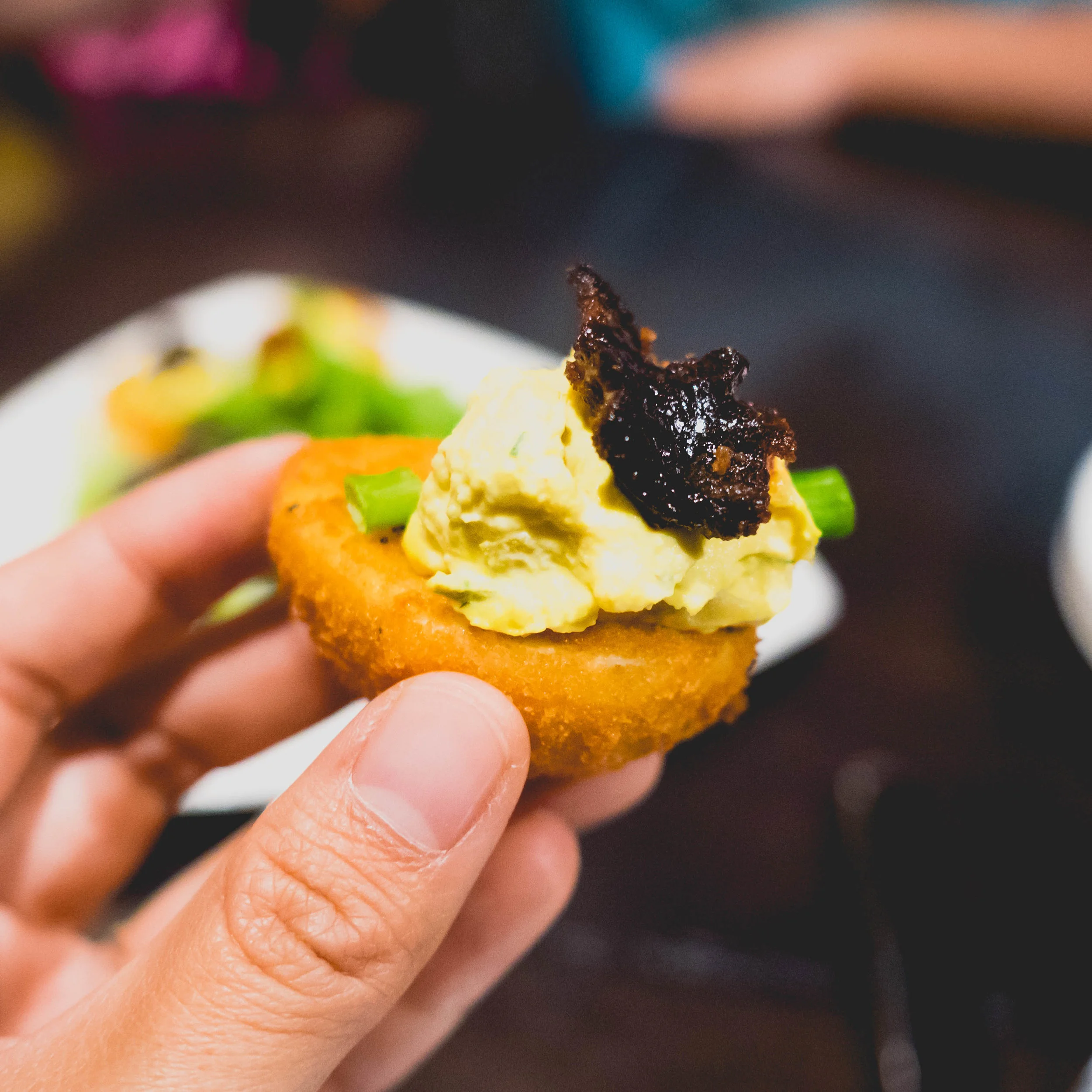 deep fried deviled eggs: panko-crusted egg, sriracha, candied bacon, green onions.