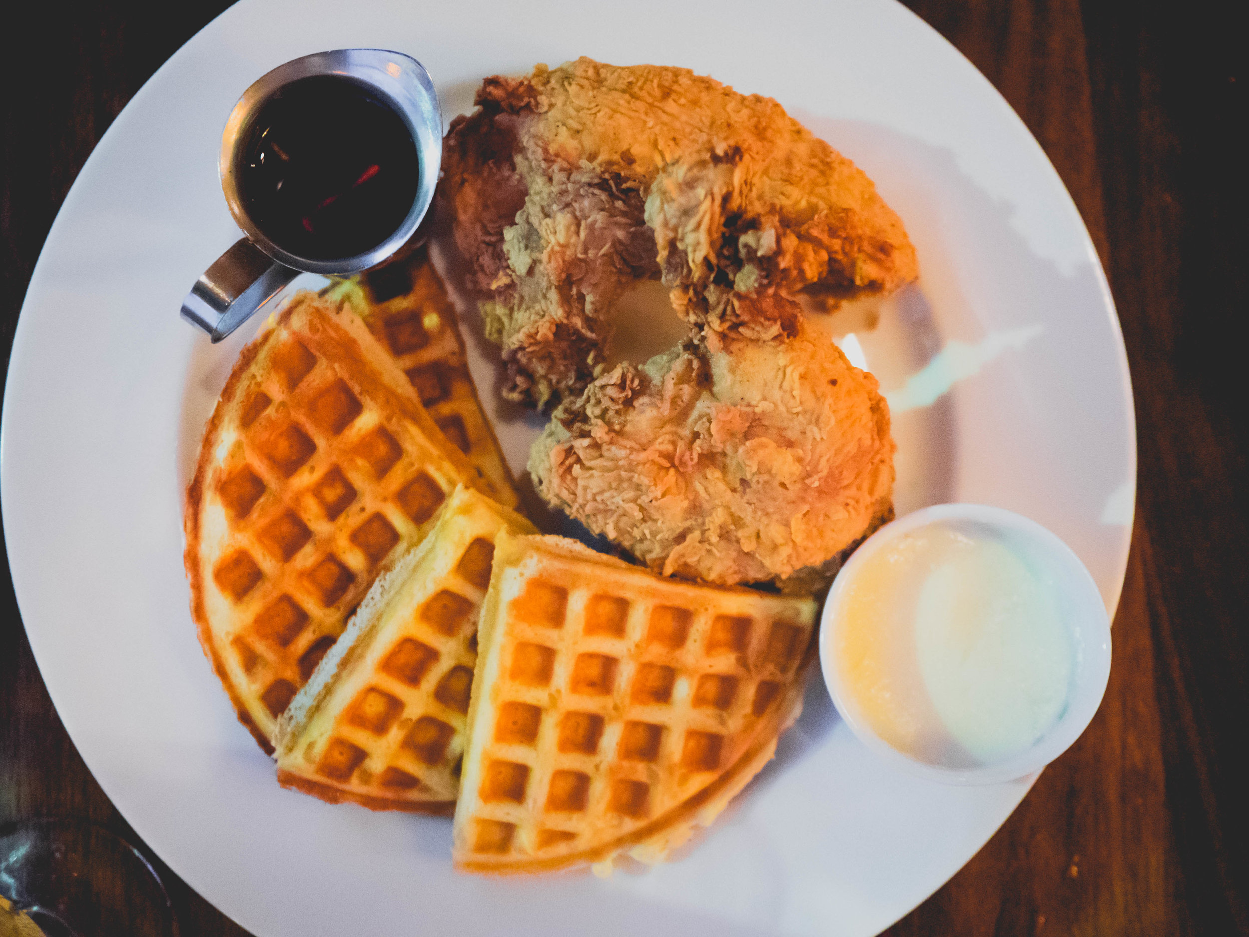 buttermilk fried chicken and waffles , butter, maple syrup.