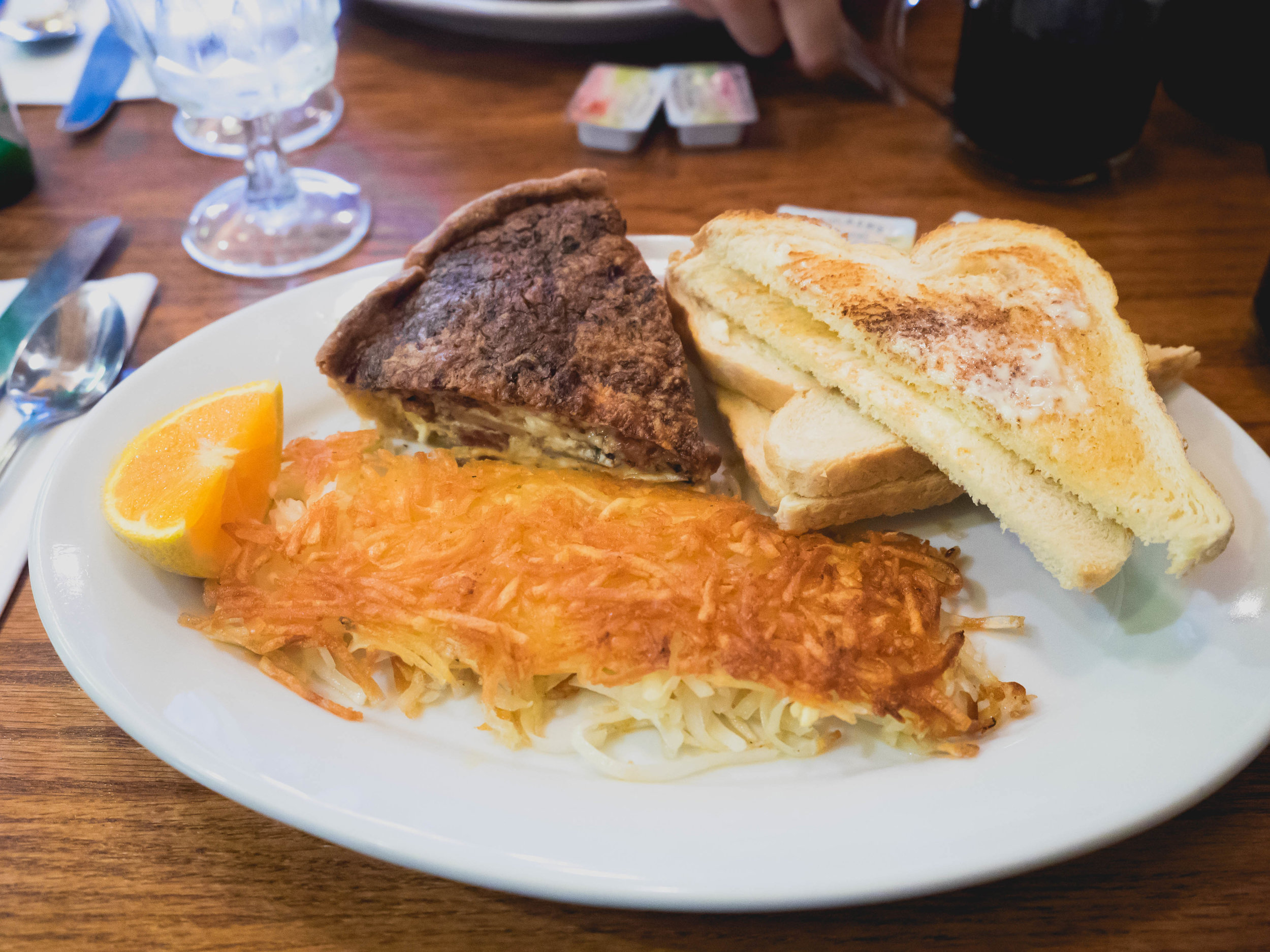 quiche with hash browns and toast.