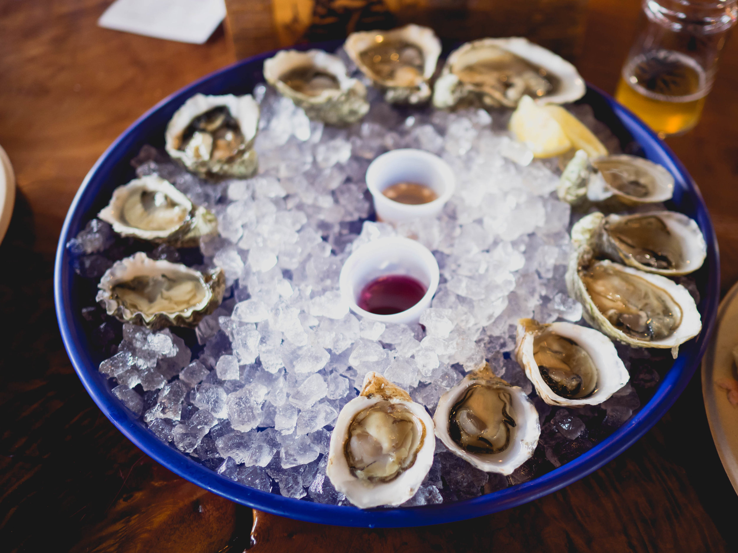 a dozen fresh shucked oysters .