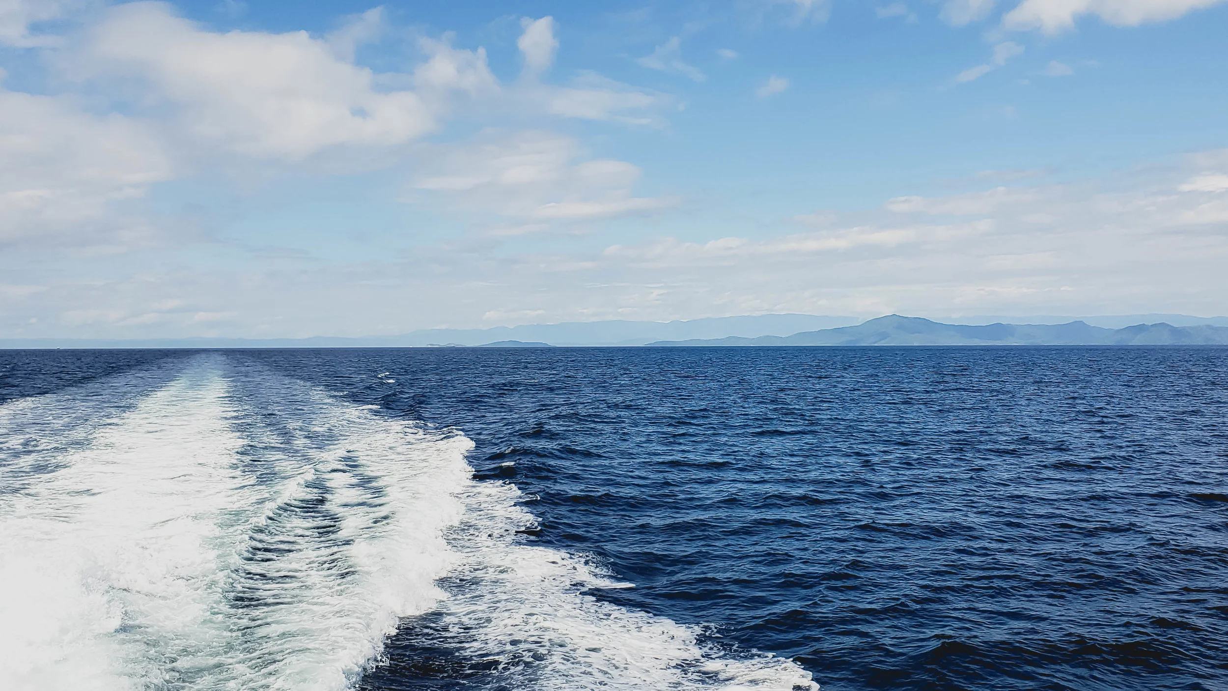 heading to the dive site, queensland in the background.