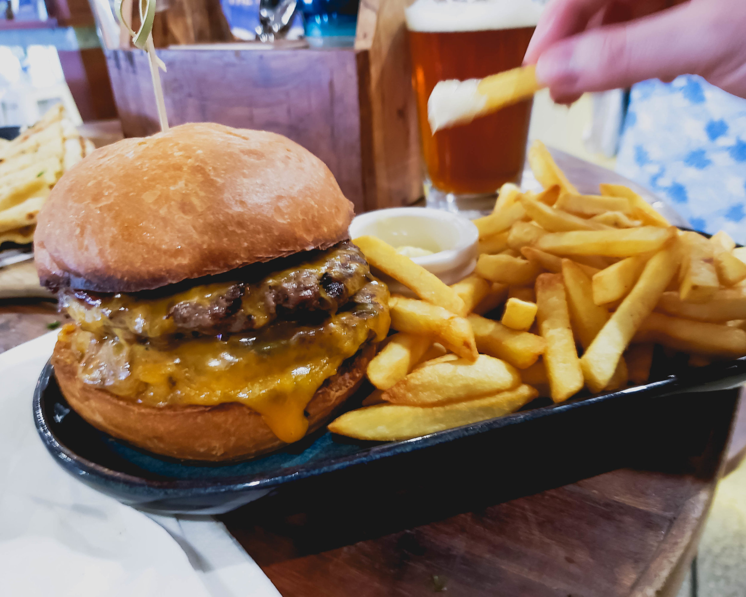 double hero burger with wagyu beef, red onion jam, american chedar, smoked mayo, bacon, lettuce, tomato, fries.