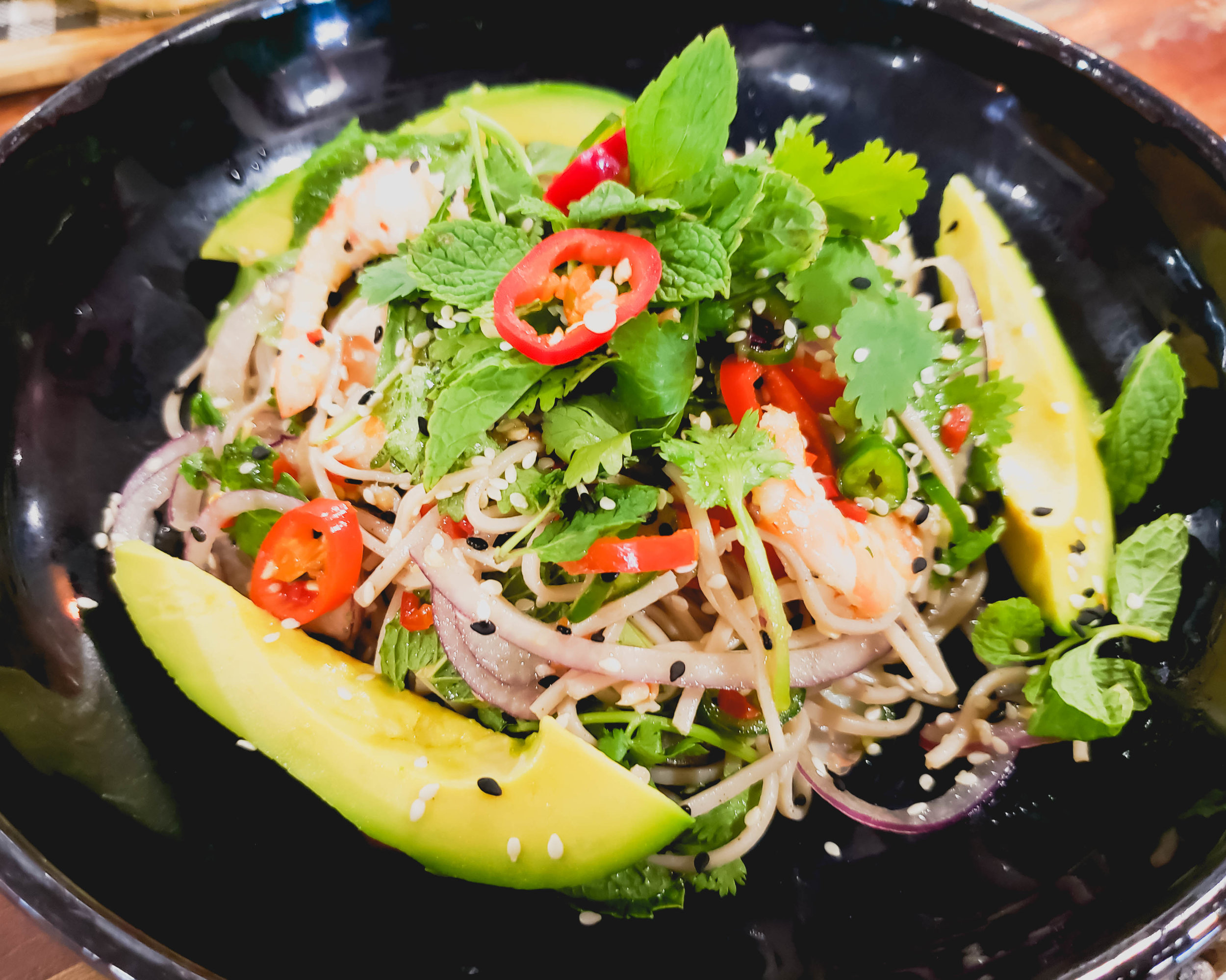 tiger prawn & soba noodle salad with red chilli nam jim, avocado, herbs, ginger, sesame.