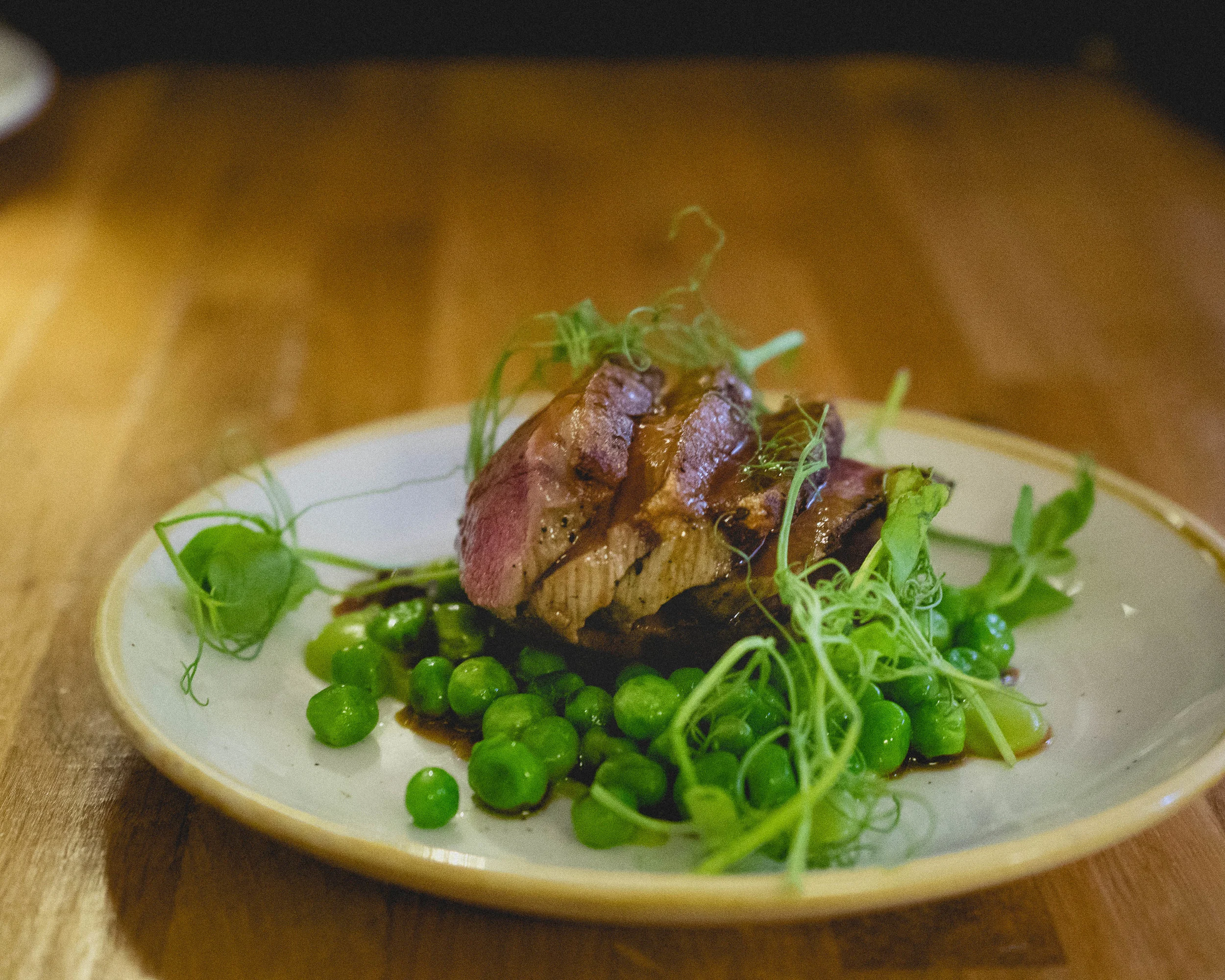 roast lamb loin , pea and broad bean fricassee, madeira jus.
