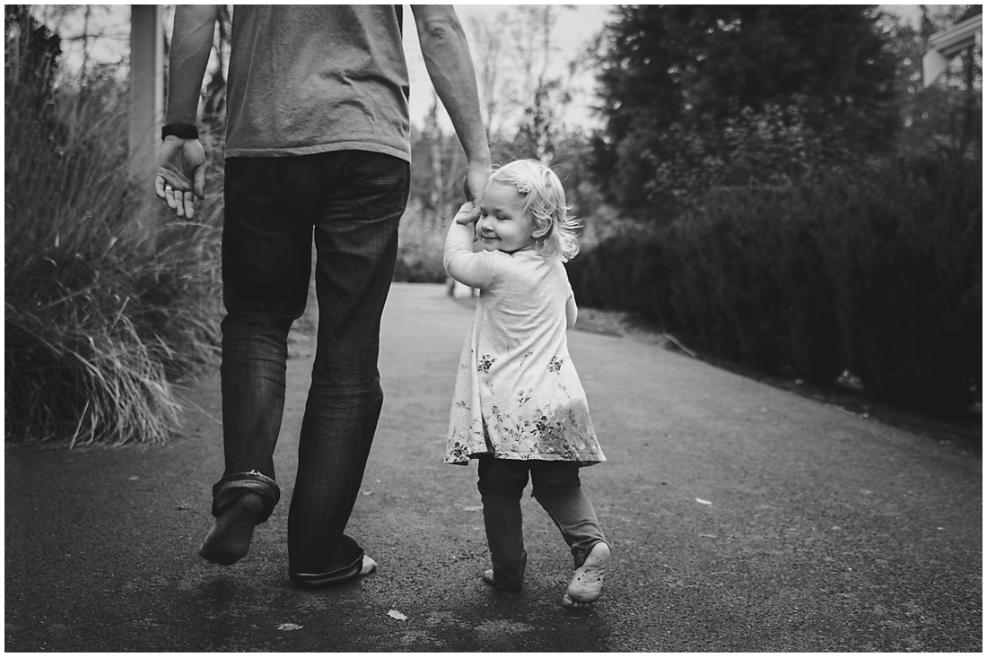 father and daughter walking down driveway holding hands #documentaryphotography #lifestlyephotography #vancouver #langley #fraservalley #mother #father #kids #trampoline #jenga #booknook #lifestyle #inhome #fall #familyof5 #fourthbaby #maternity #reading #whitekitchen #activefathers #playwithyourkids