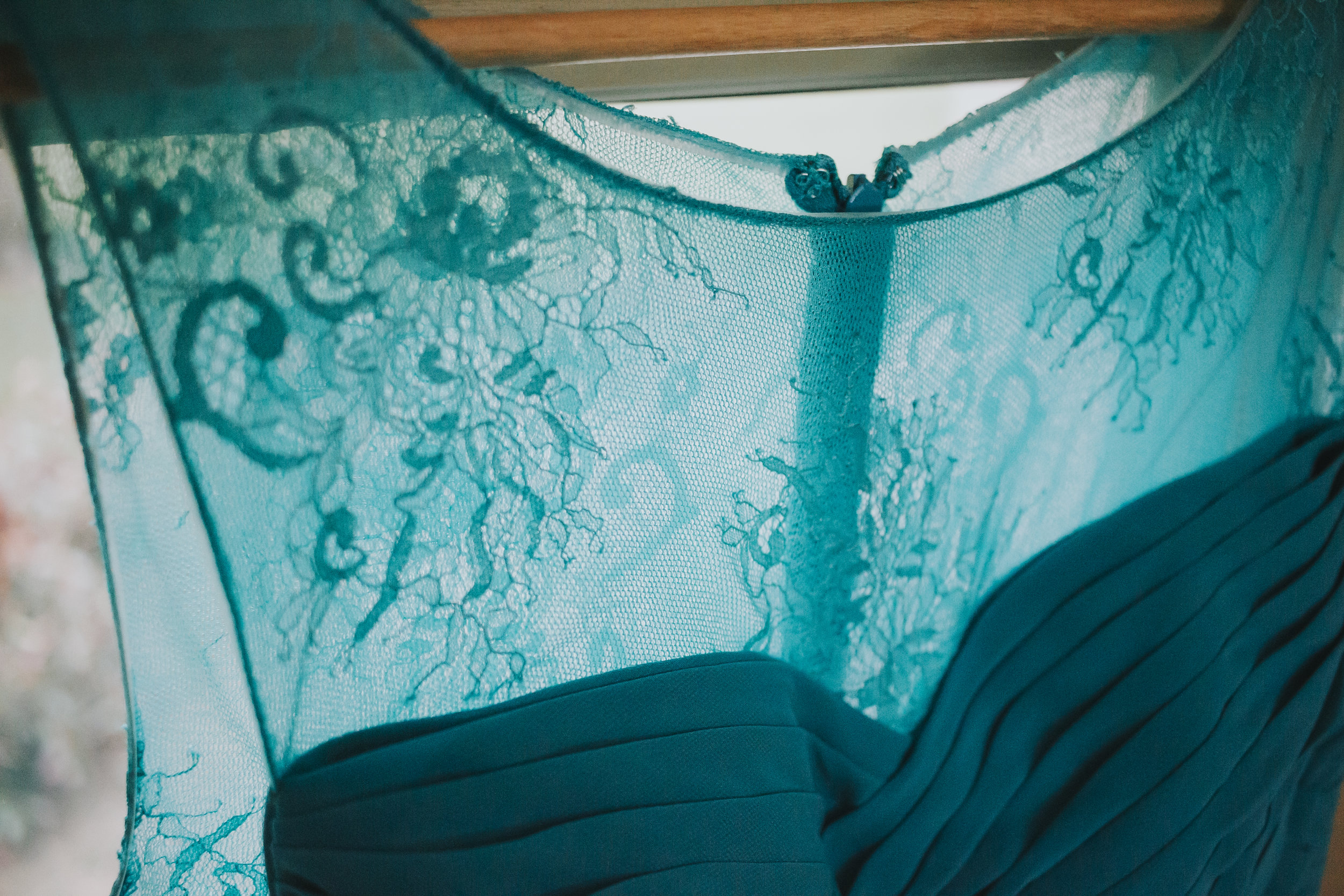 Teal blue bridesmaids dress detail. A rainy forest wedding in Lynden Washington, featuring teal blue accents, rustic details, umbrellas and a large bridal party. #rain #wedding #lynden #washington #umbrella #spring #teal #grey #brown #trees #romantic #documentarywedding #unposed #romanticposes #couple #largebridalparty Photography by Christina Voorhorst of Mimsical Photography. Do not alter, crop, edit or share these images without proper credit or permission. www.mimsicalphotography.com 