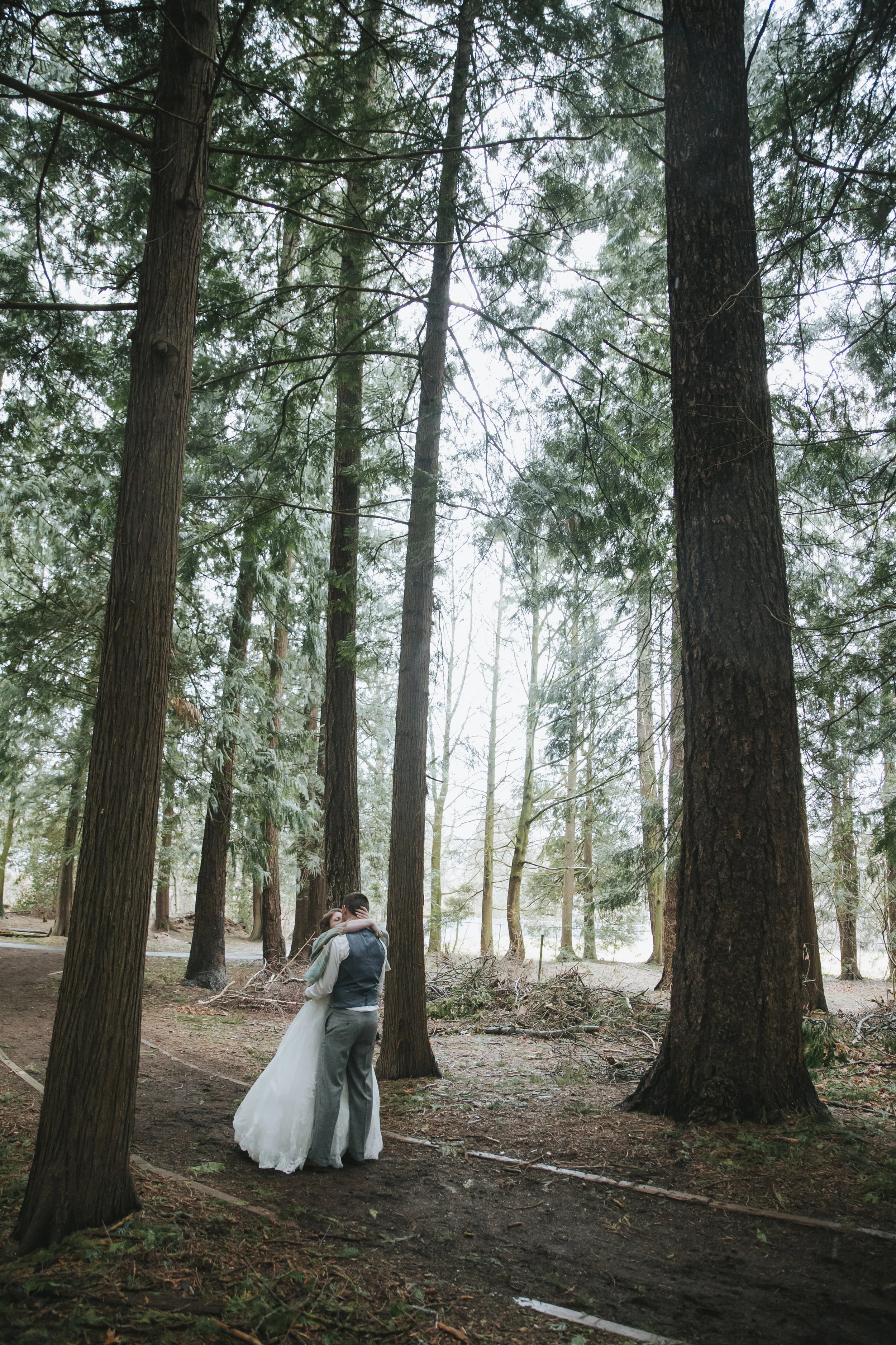 First kiss during first look in the forest A rainy forest wedding in Lynden Washington, featuring teal blue accents, rustic details, umbrellas and a large bridal party.#rain #wedding #lynden #washington #umbrella #spring #teal #grey #brown #trees #romantic #documentarywedding #unposed #romanticposes #couple #largebridalparty Photography by Christina Voorhorst of Mimsical Photography. Do not alter, crop, edit or share these images without proper credit or permission. www.mimsicalphotography.com 