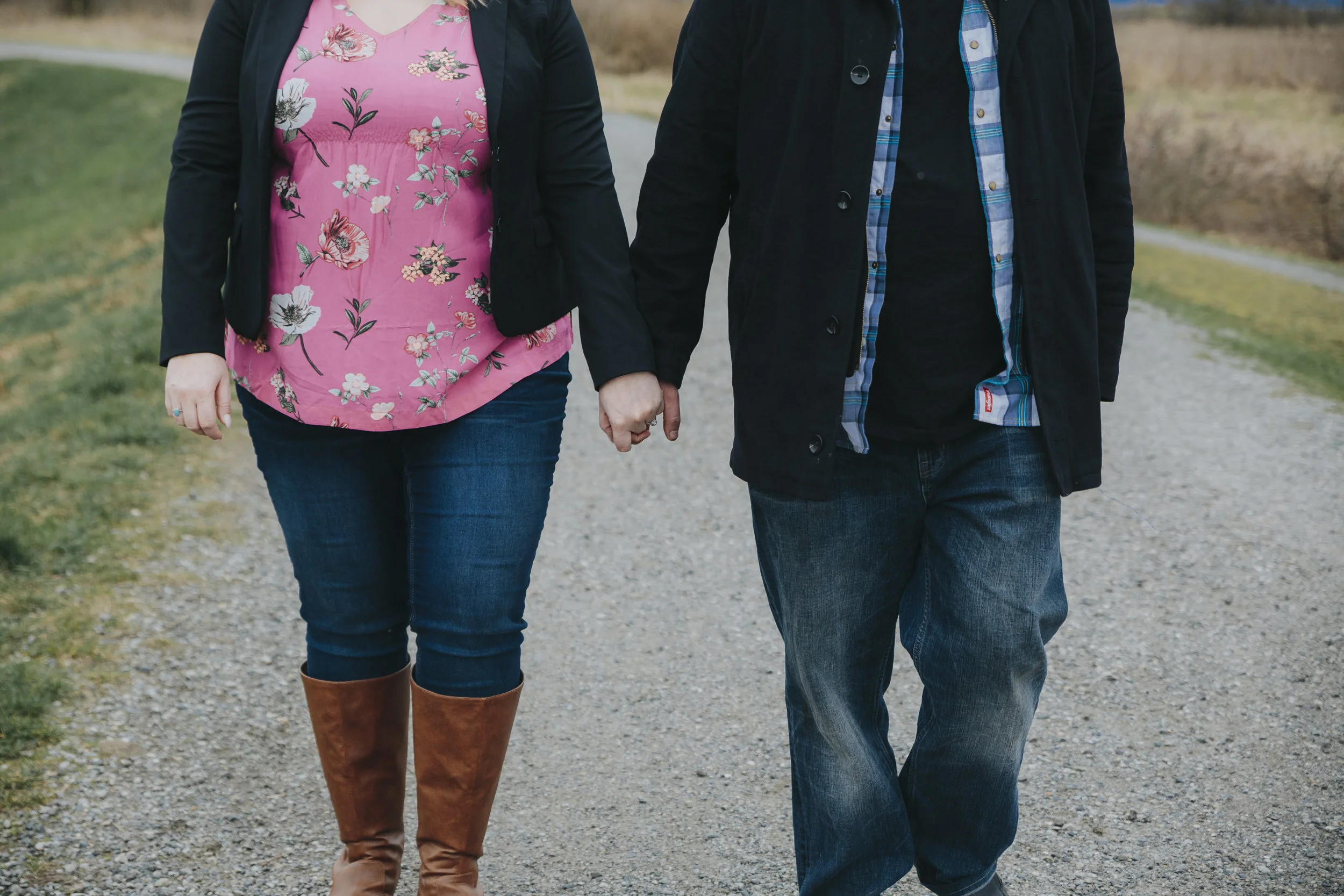 Cloudy engagement session at Garry Point Park in Richmond, BC. Couple holding hands walking Photography by Christina Voorhorst of Mimsical Photography #westcoastphotographer #engagement #ring #couple #ocean #cloud #overcast #romantic #poses