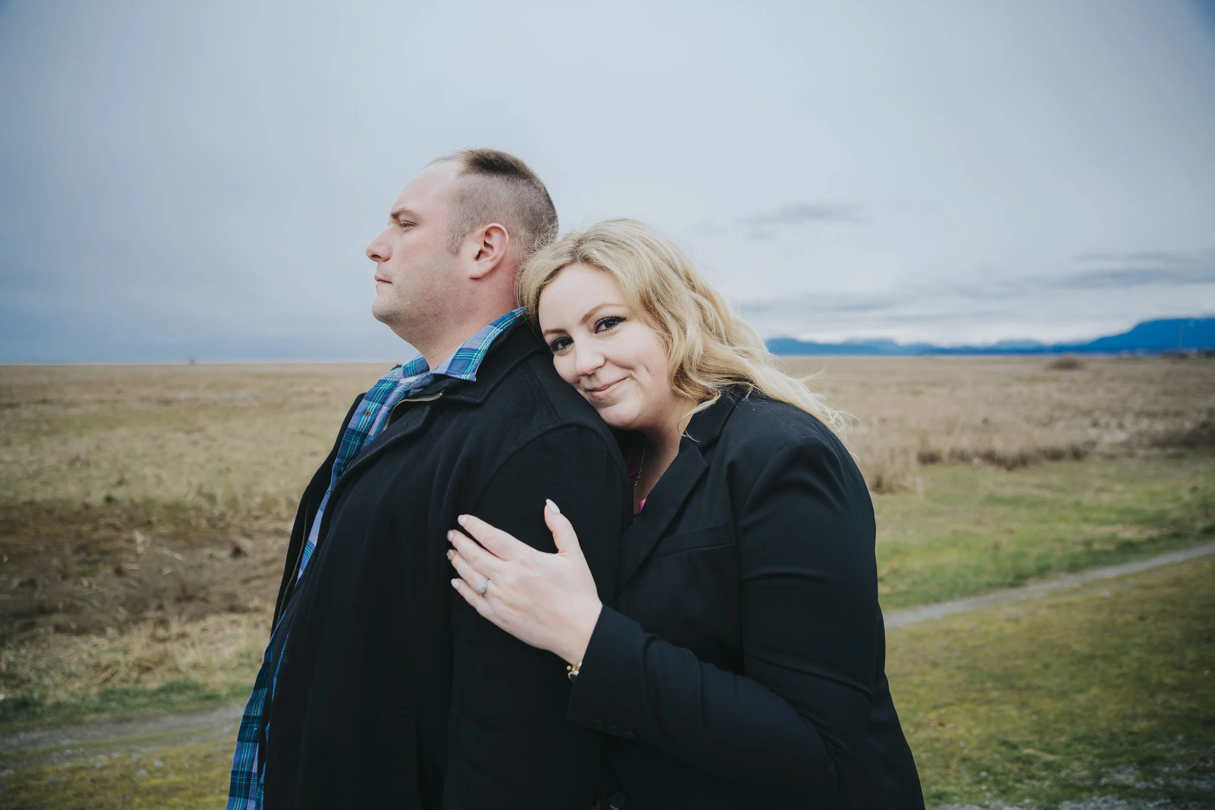 Cloudy engagement session at Garry Point Park in Richmond, BC. Photography by Christina Voorhorst of Mimsical Photography #westcoastphotographer #engagement #ring #couple #ocean #cloud #overcast #romantic #poses