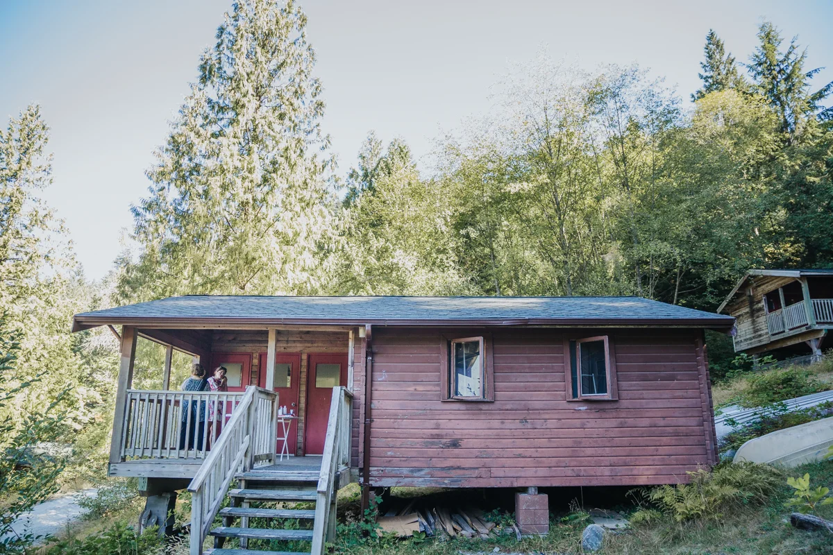 bridal prep in cabin Mimsical Photography Documentary Wedding Photography, Camp Howdy, Belcarra Provincial Park, North Vancouver. Purple and Grey Wedding Colours, Natural Greenery, Rustic Details, Summer, Lace and chiffon, big wedding, greek, lower mainland, british columbia, real, genuine, candid 