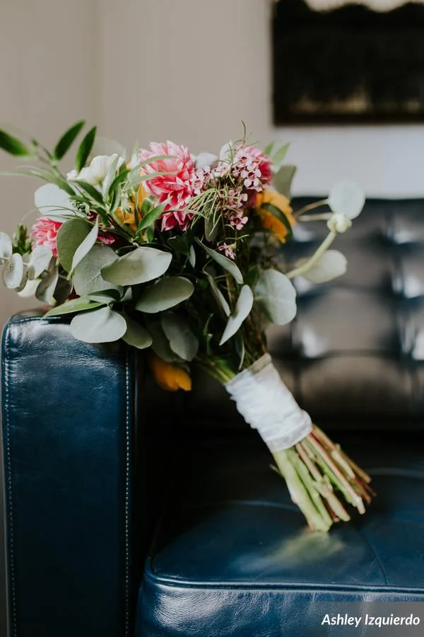 Bright, organic bunches of florals popped against black bridesmaids dresses and linens.