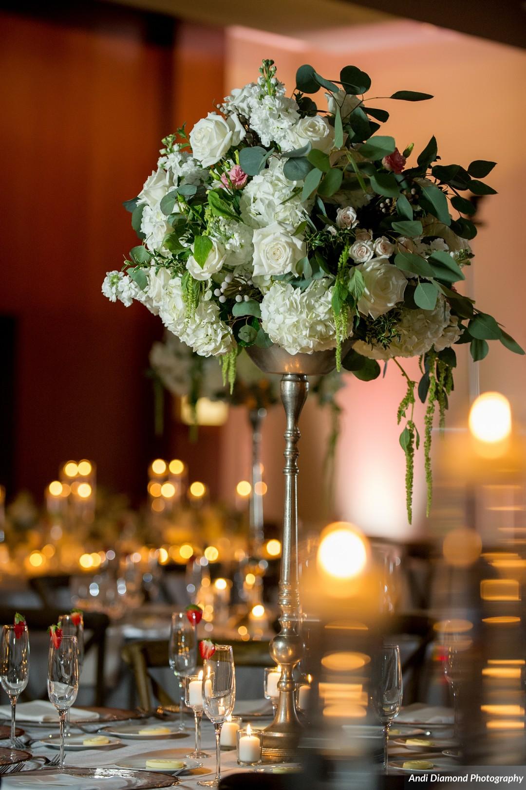 A mix of towering florals and candlelight with the natural color scheme created a perfect blend of sophistication and simplicity.
