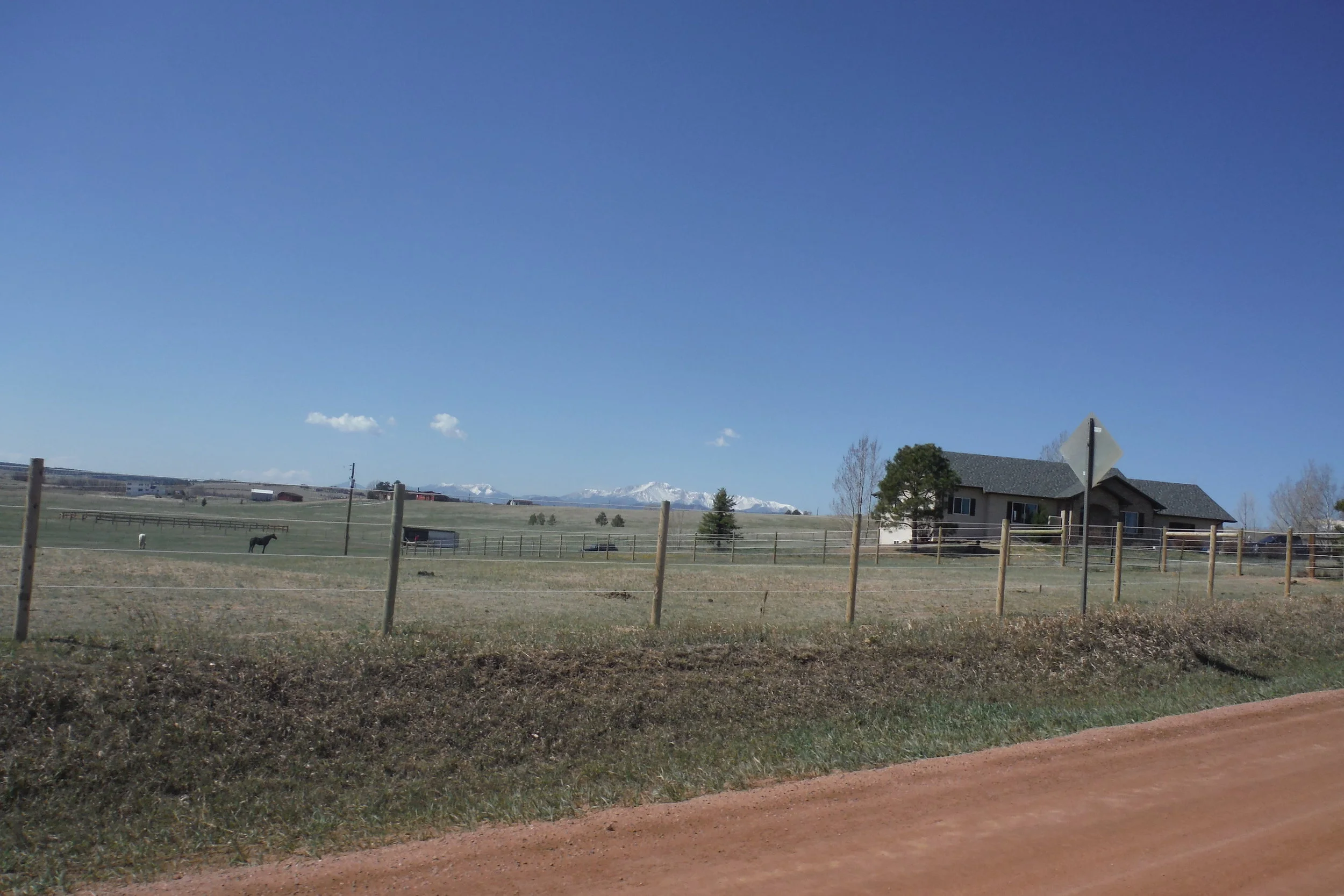 The course wound predominantly through cattle &amp; horse ranches, the occasional rock outcroppings on the edges of a wash or the crest of a hill with mountains in the western distance.