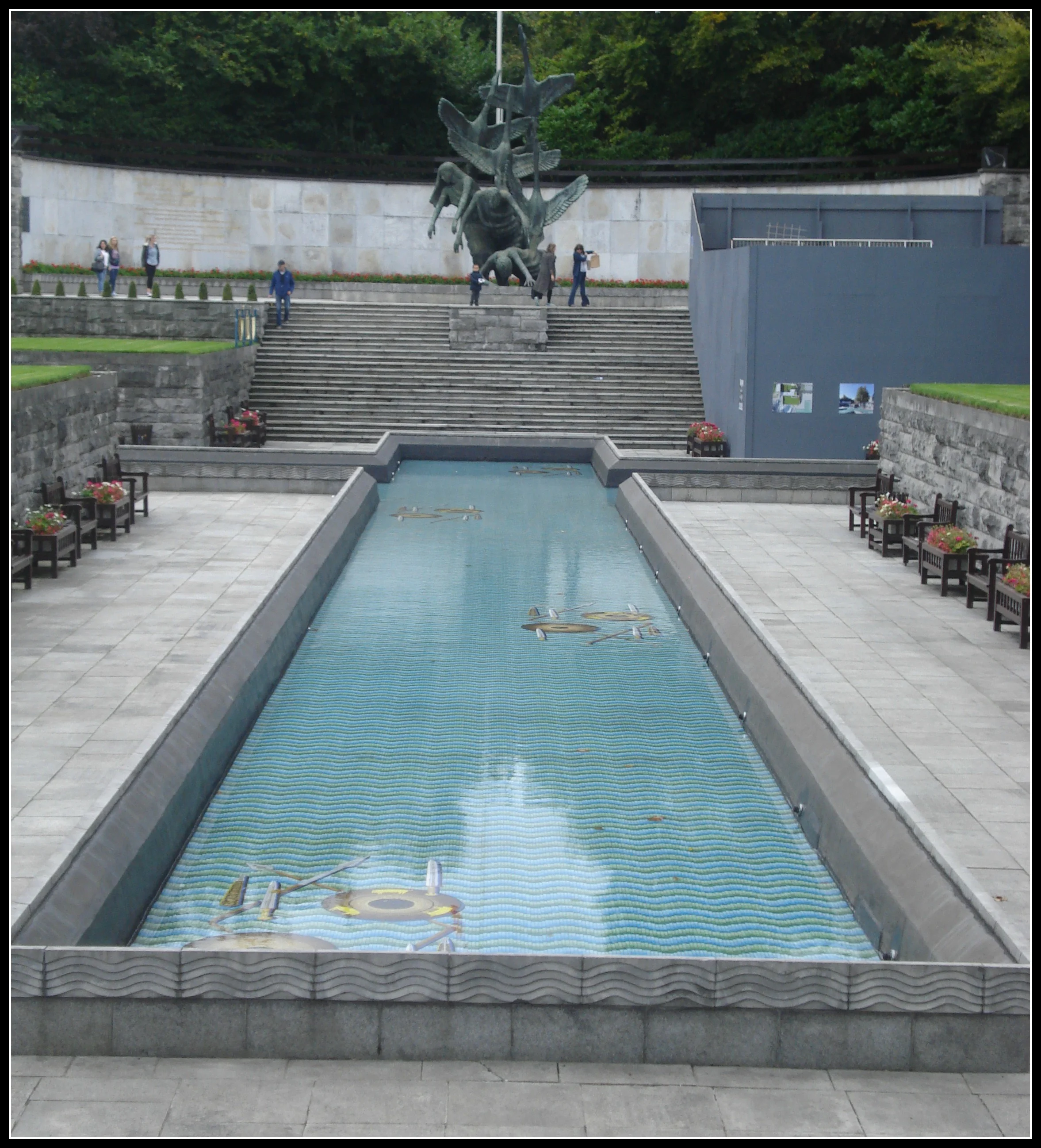 The pool guides your eye upward toward the sculpture.
