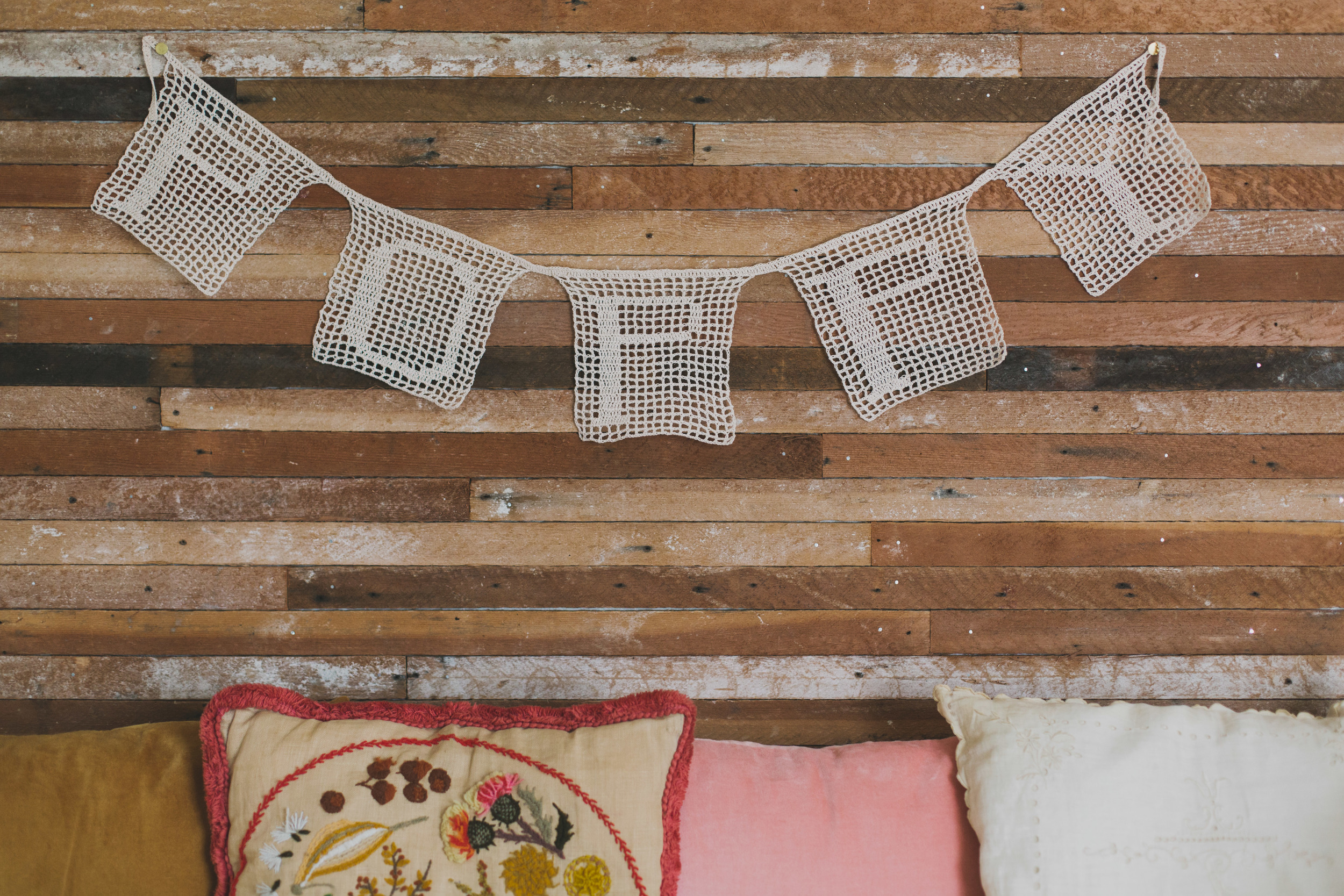 middle-of-the-night pregnancy insomnia produced this fillet crochet banner for poppy! josh & i hung the lath on this wall together.