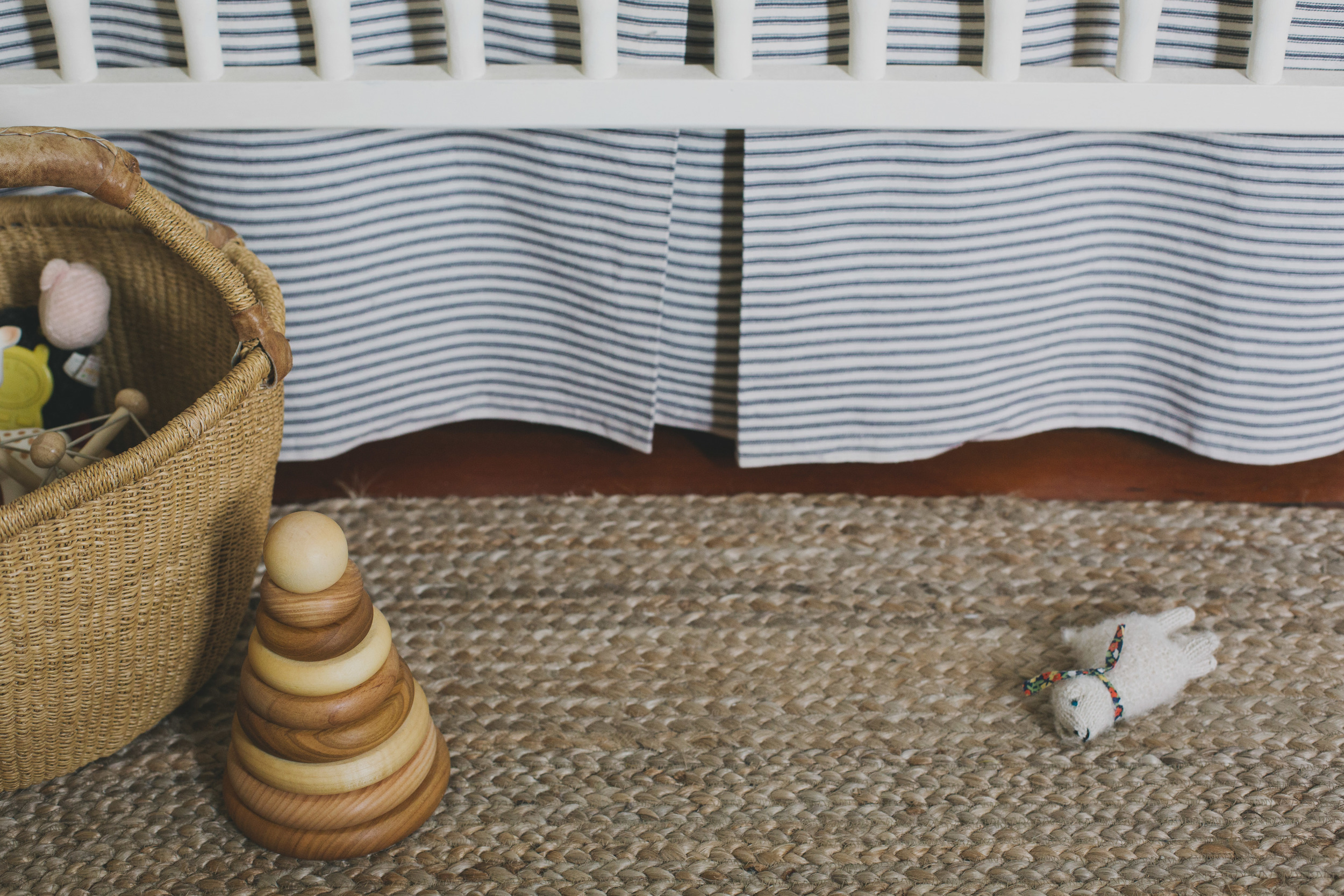  i made sheets out of unbleached muslin, a box pleat crib skirt out of ticking stripe, and tea-stained a white crib bumper for a warm ivory color (not shown). perry's old spindle crib received a face lift with chalk paint (first sanded, then painted with annie sloan's "old white," distressed, and finally given a wax coat on top).