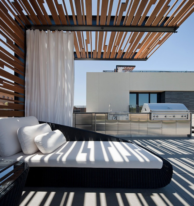 Tresarca Residence image via: assemblageSTUDIO With an outdoor kitchen and a daybed, this is a luxurious rooftop living area. Use curtains and textured structures to add shade that won't hinder your view. 