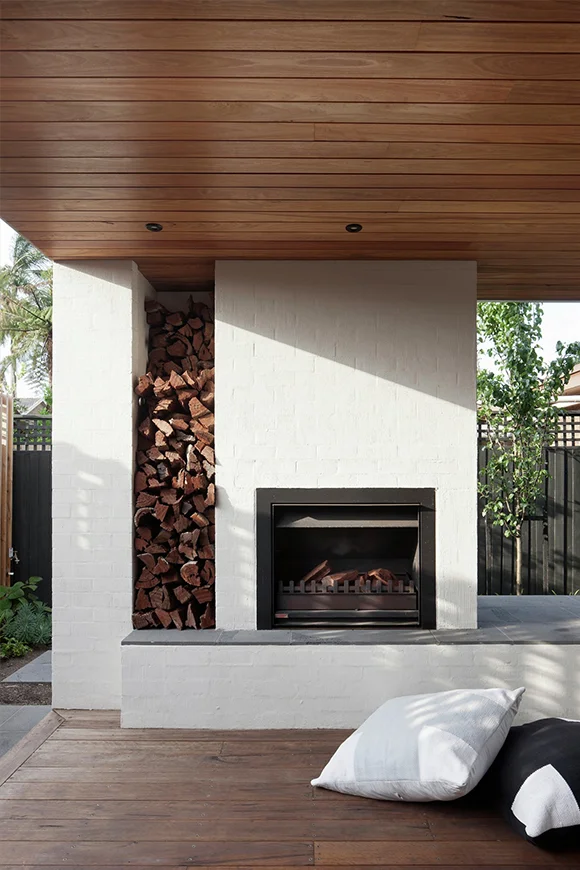 When planning a built-in fireplace, think about where you will store your firewood too. Image via  Gardenista .