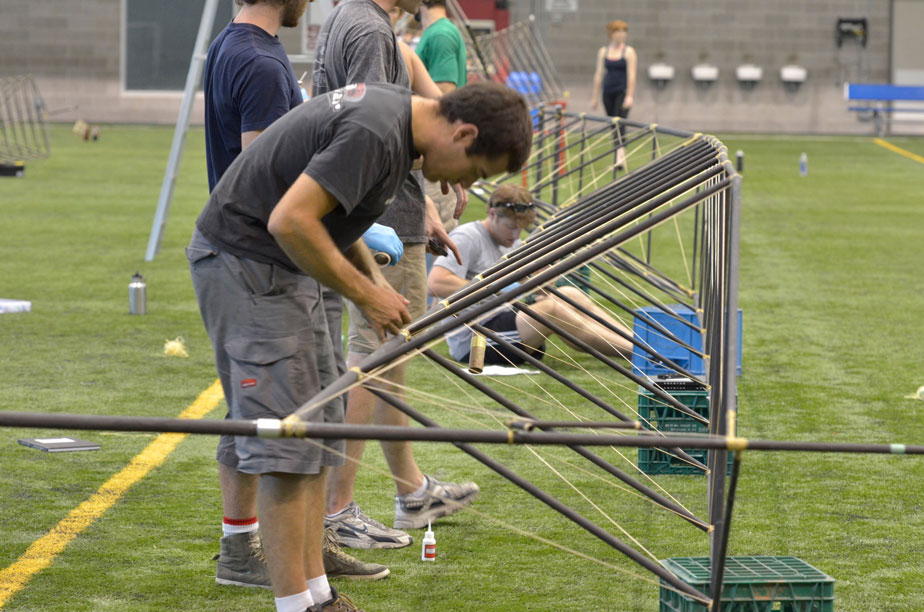 Aidan attaches the Vectran bracing lines to the top of one of the truss arms (photo credit Mike Campbell/ckmmphotgraphic)