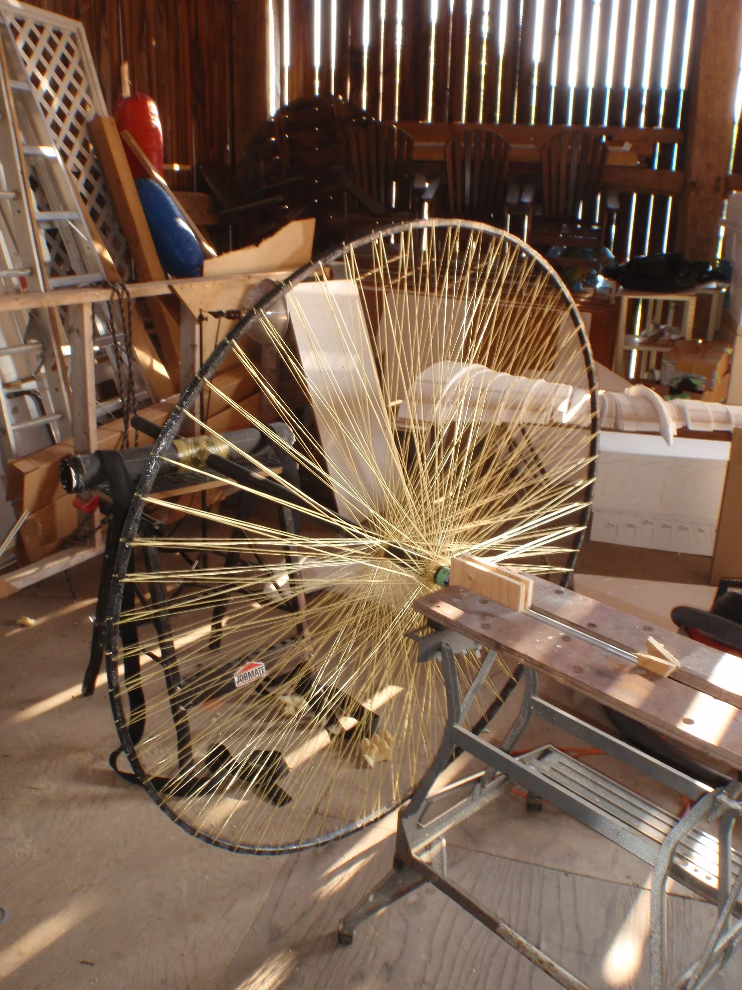 The drive spool has been mounted on a pair of saw horses for testing. The support near the spool is free to rotate, while the T-joint behind the spool is fixed in place.