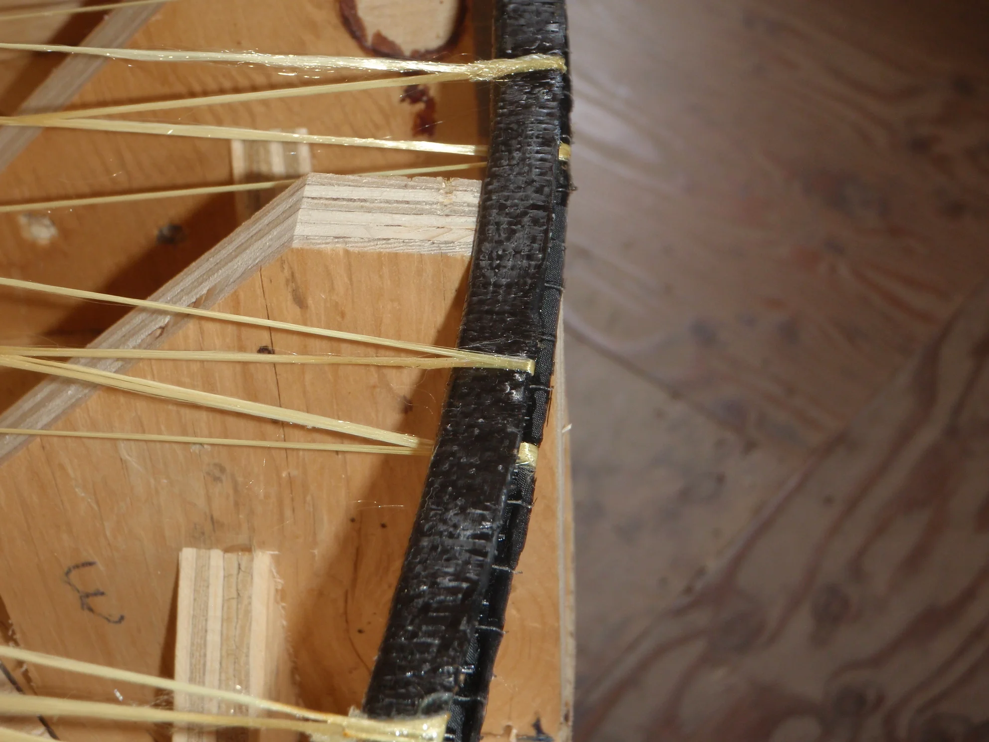 Shown is the spool rim on the jig during spoke winding. The jig supports keep the rim in the shape it is supposed to maintain until the spokes are secured.
