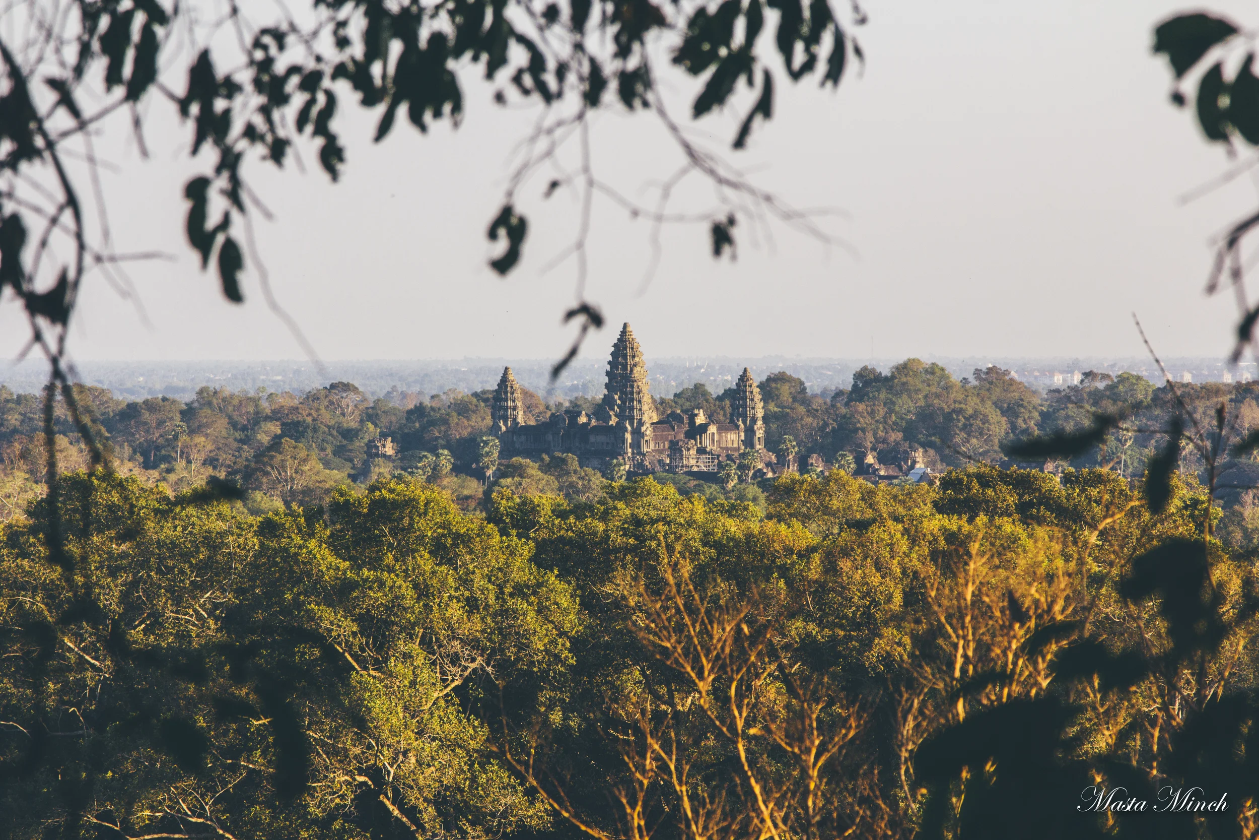 The view of Angkor Wat from the top of a hillside.