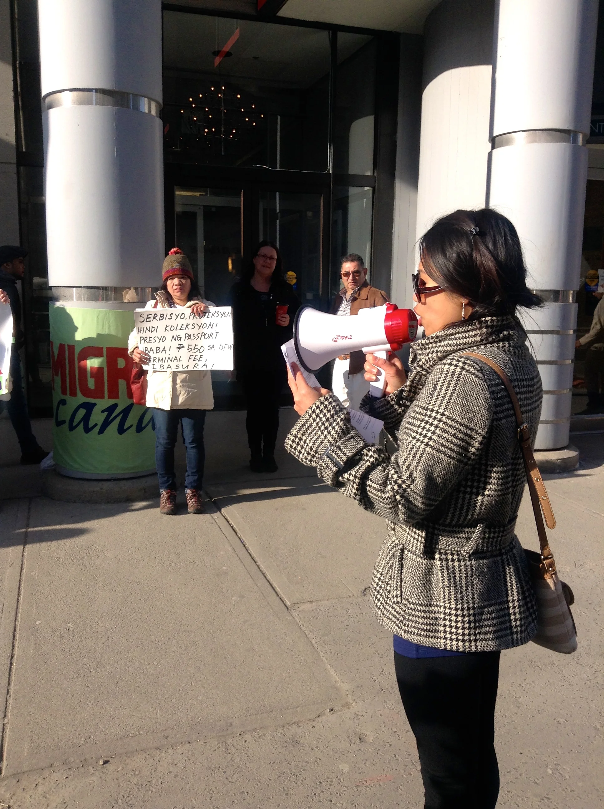 Joanna Lacar reading a piece by Tess Agustin, chairperson of Migrante Canada.