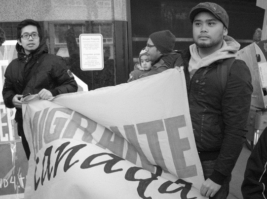 Ysh Cabana and Jesson Reyes at the Cross-Canada Day of Action rally in Toronto, Ontario. Photo by Edward Hon-Sing Wong.