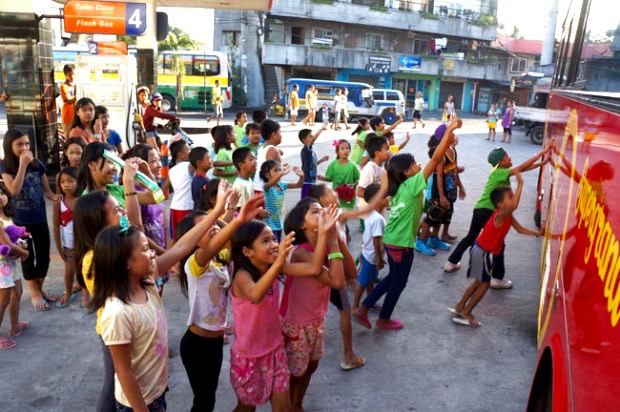 Children waving goodbye to the TCDSB students. Photo by Catholic Student Leadership