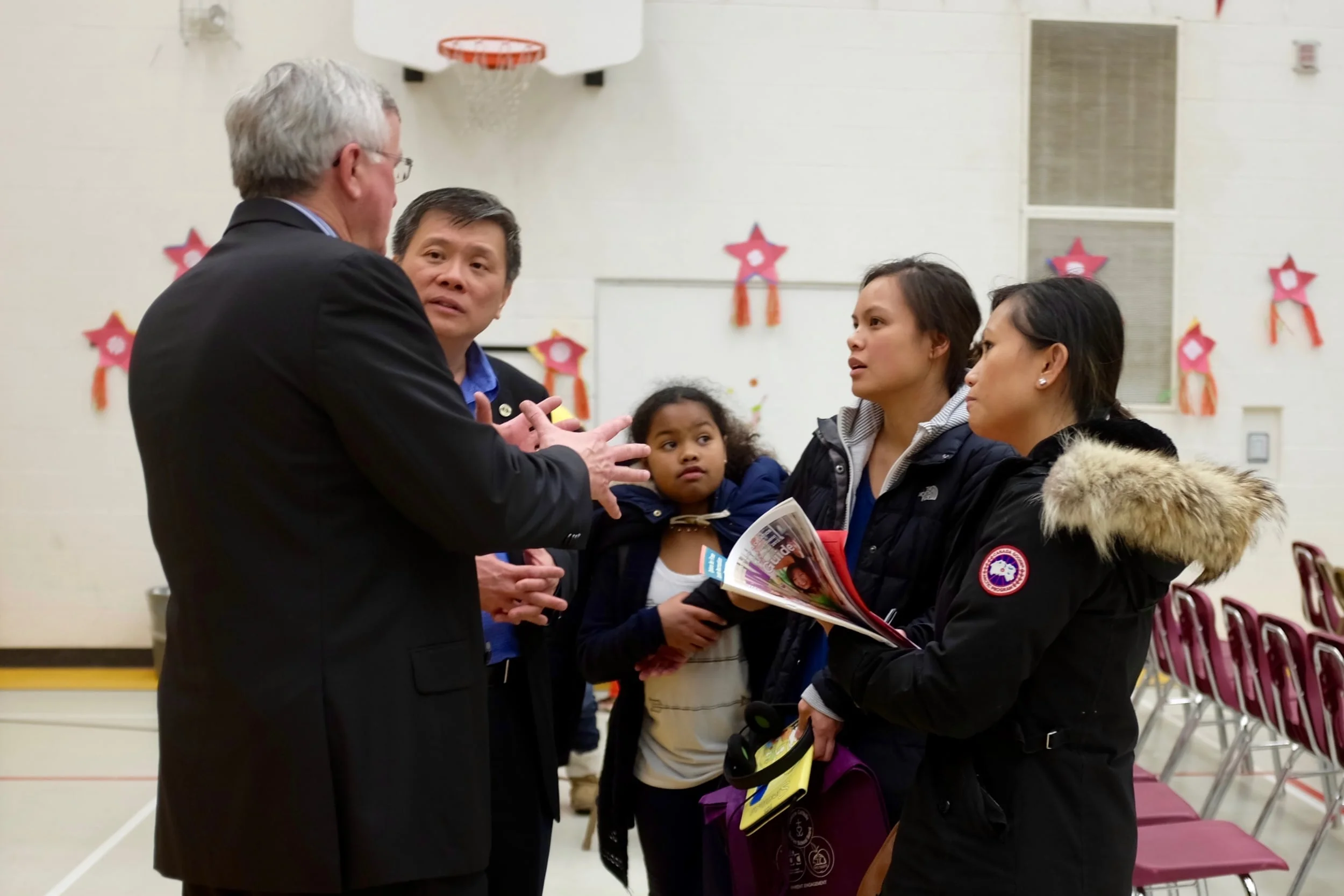 Superintendent John Shain speaks with Trustee Gerry Tanuan, Jerrylyn Gueverra and Judith Cortez at a TCDSB Filipino Christmas event.