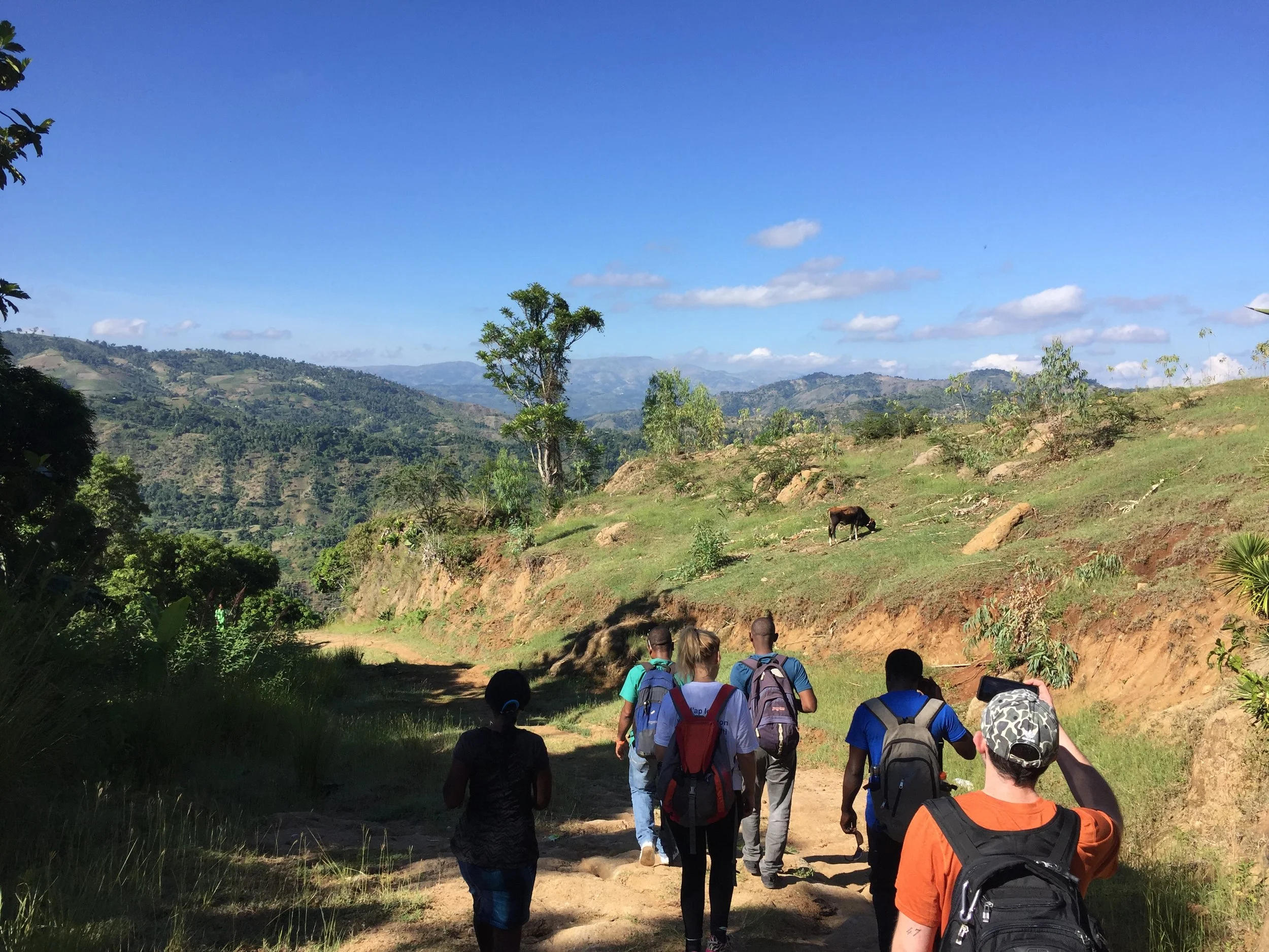 The Kore Timoun team, interpreters, and health practitioners hike to the village where they will setup the mobile clinic for the day