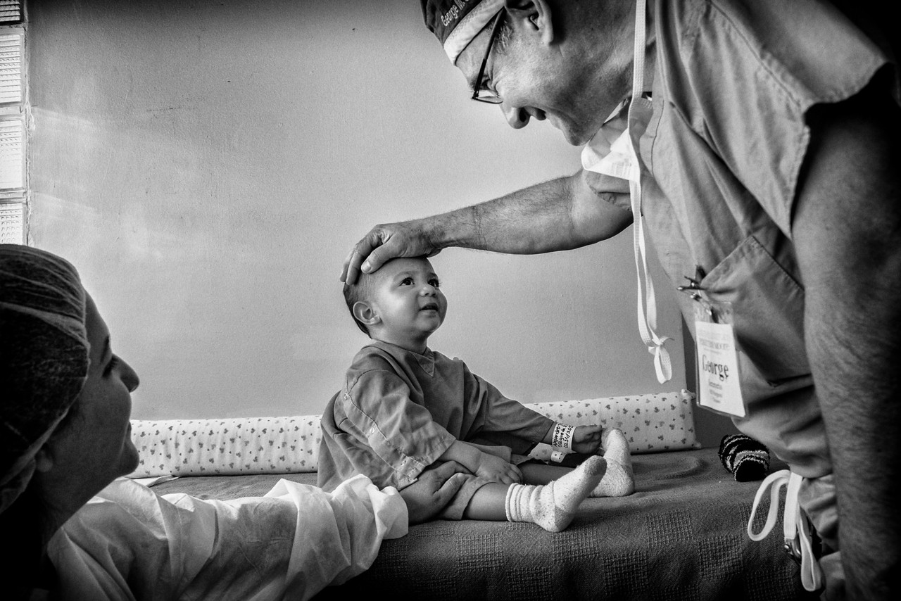 Dr. Seremetis talks with a patient and his mother before surgery. Moore Pediatric Surgery Center, Guatemala City. From Dell Children's Surgical Global Outreach 2012