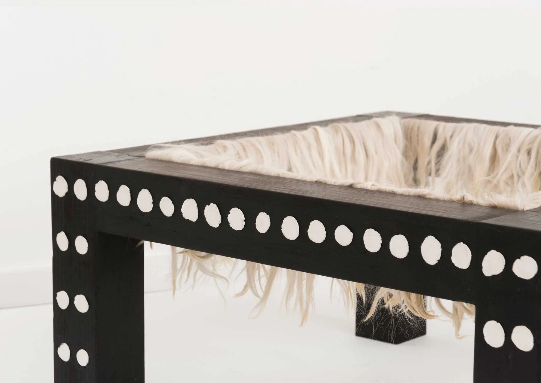 Soothe Table (Pacify) (detail), 2015 Charred poplar, self-drying clay, alpaca 20 x 20 x 10 inches Image courtesy of Volume Gallery, Chicago, IL