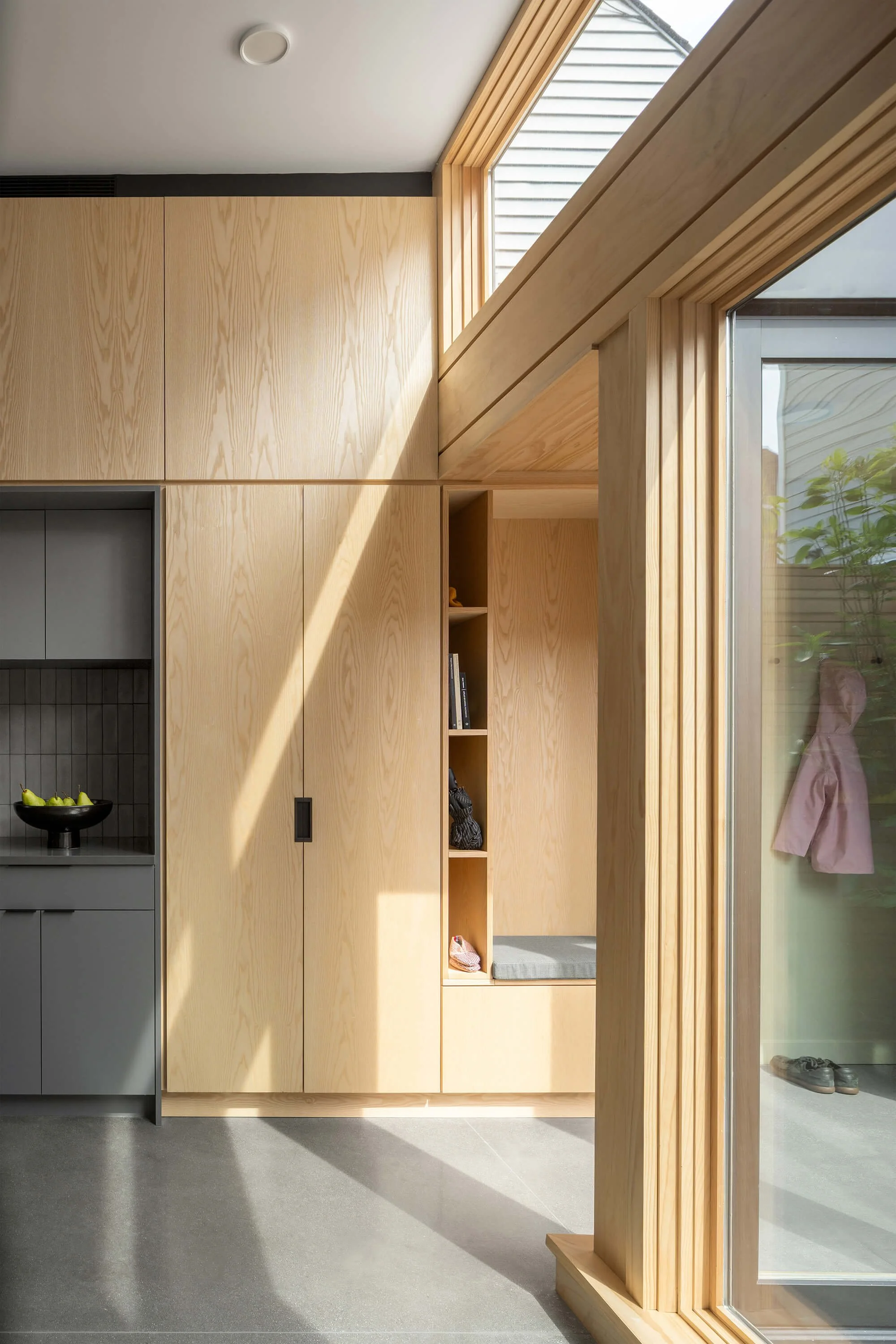 Kitchen interior of YIMBY House in Jersey City designed by Behin Ha Studio with clean lines, integrated millwork, and contemporary finishes.