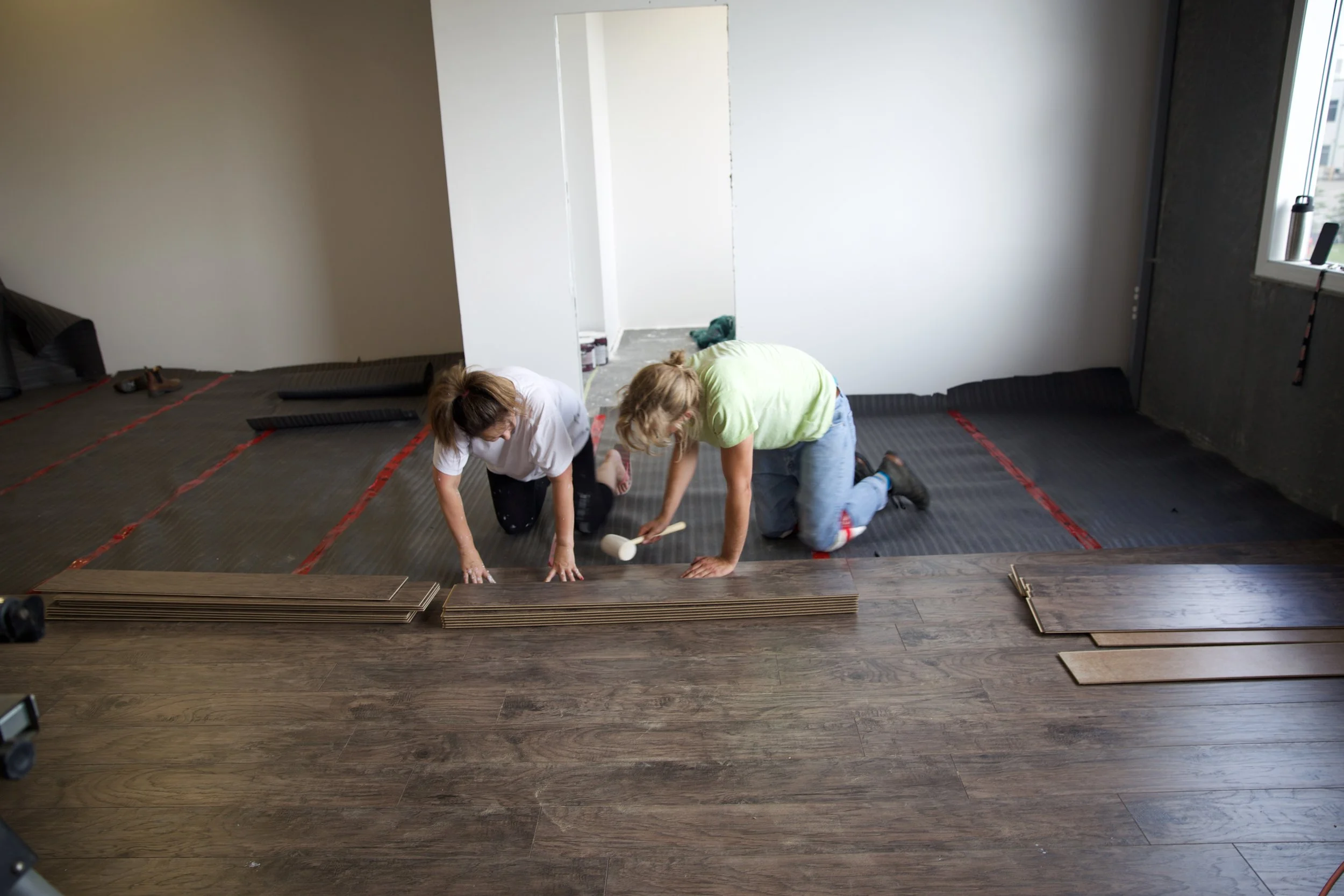 Karen and Adam laying floors