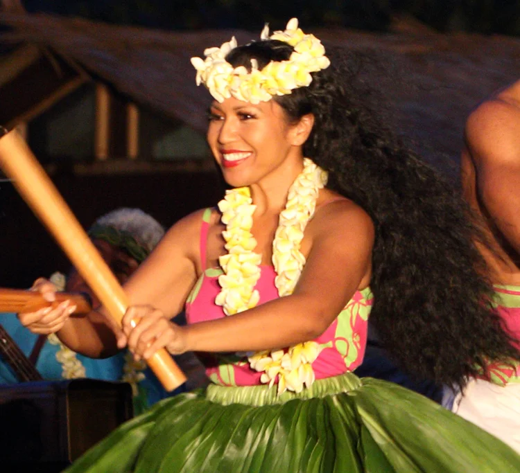 Malu Polynesian dancer smiling during a live cultural performance