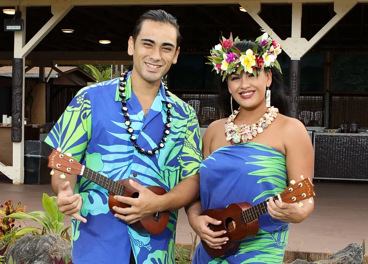 Malu musicians holding ʻukulele at a performance venue