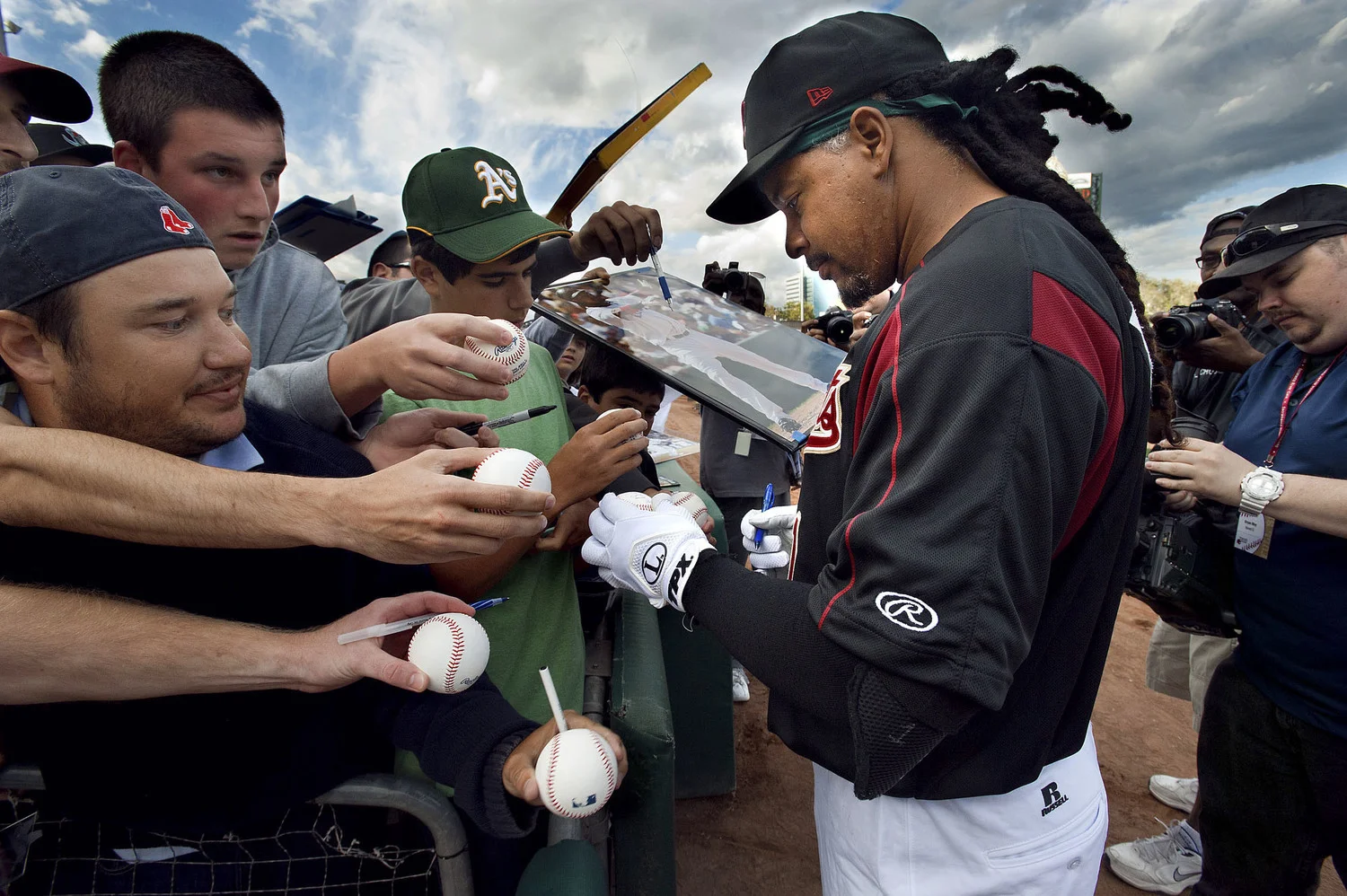 The River Cats' left fielder Manny Ramirez (11) signs autographs briefly prior to the game between the Sacramento River Cats and the Reno Aces at Raley Field in West Sacramento on Friday, May 25, 2012.