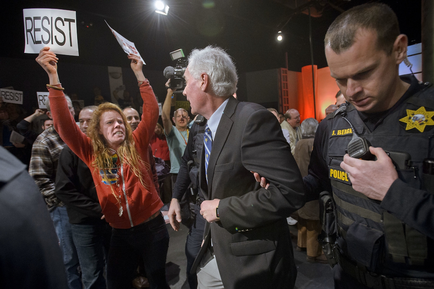  Congressman Tom McClintock (R) 4th District California, center, is escorted by Roseville Police through a hostile audience from the Tower Theater in Roseville on Saturday, February 4, 2017.&nbsp; McClintock held a town hall meeting at the theater an