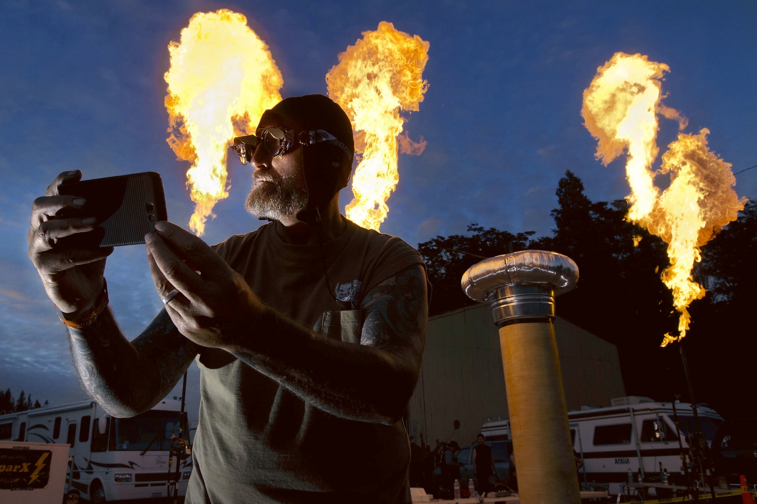  "Wild" Bill Hill takes a photo of himself in front of large bursts of fire during the 'Fire and Steel' event in Colfax on Saturday, June 14, 2014 