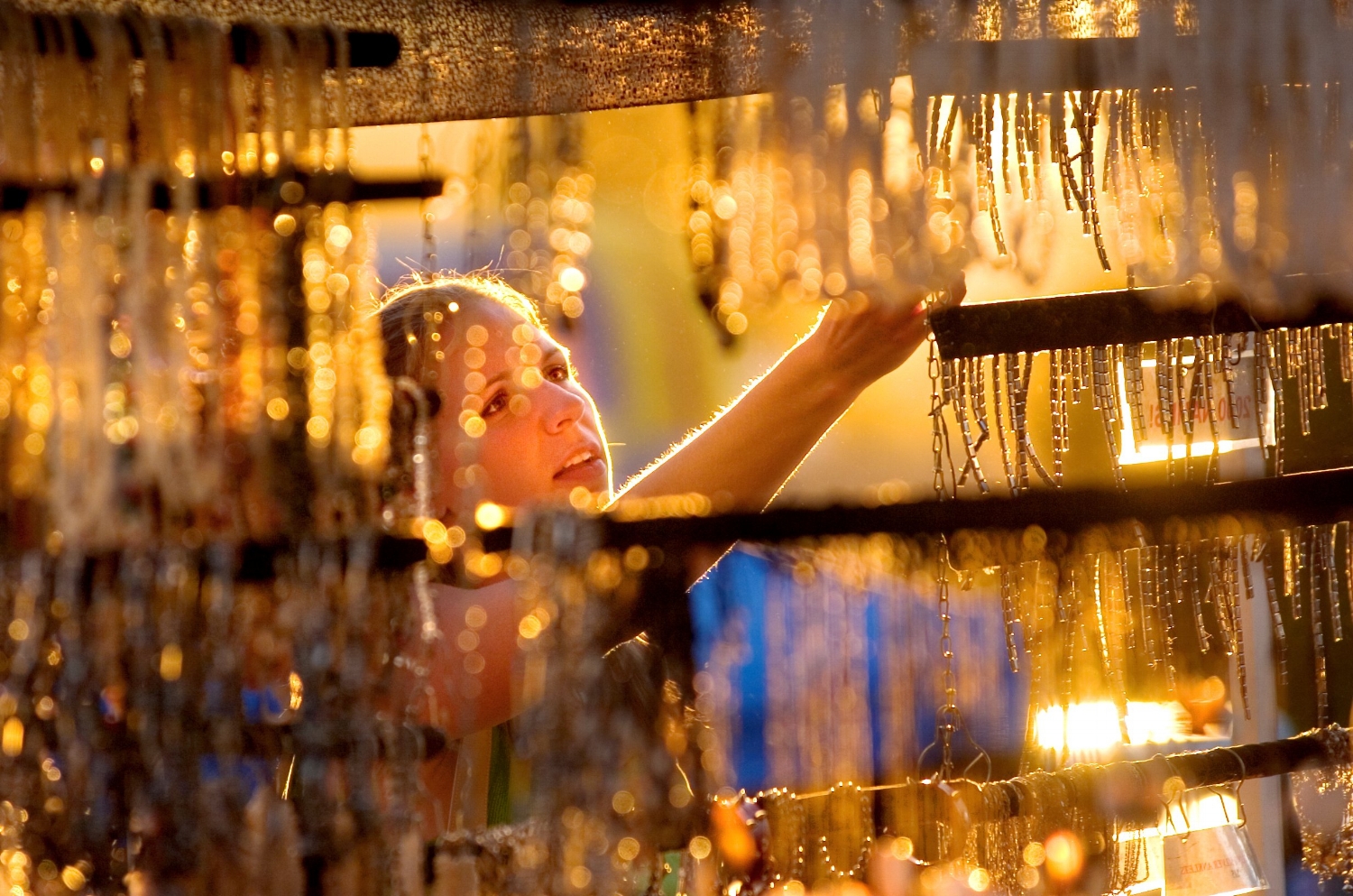 Casey Long 21 of Seattle shops for jewelry at a booth at the Thursday Night Market in Folsom on Thursday July 7, 2005.
