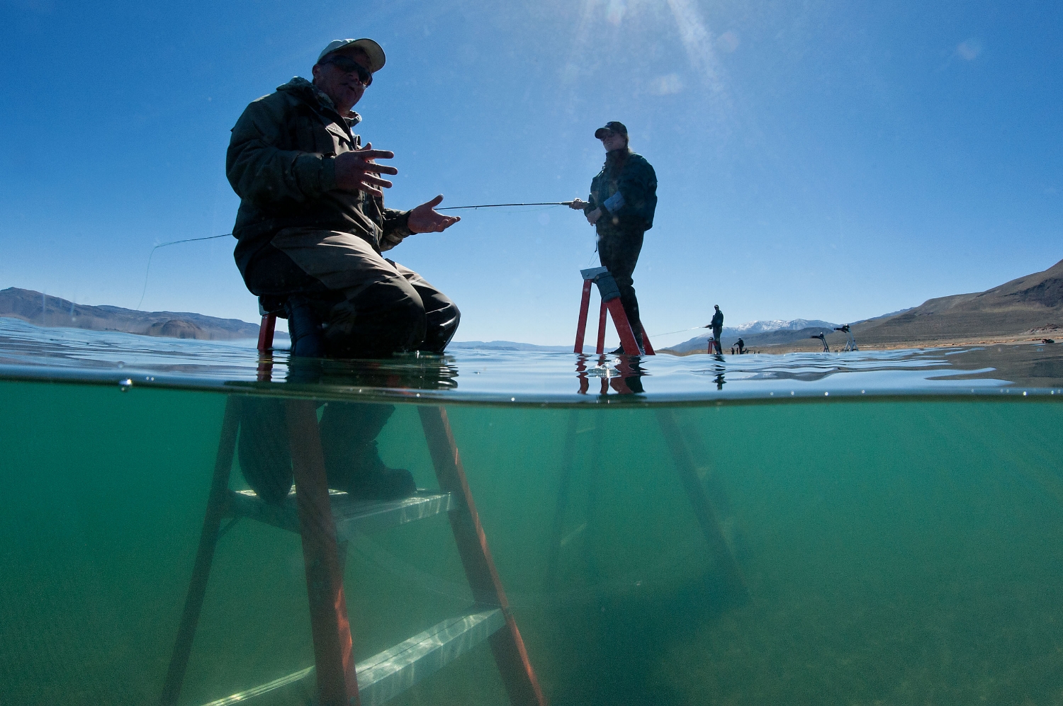  Fly fishermen sit on ladders to fish for Pyramid Lake strain of Lahontan cutthroat trout at Pyramid Lake in Nevada on Thursday, April 18, 2013. The largest freshwater trout species in the world was once-thought extinct but has been re-discovered and