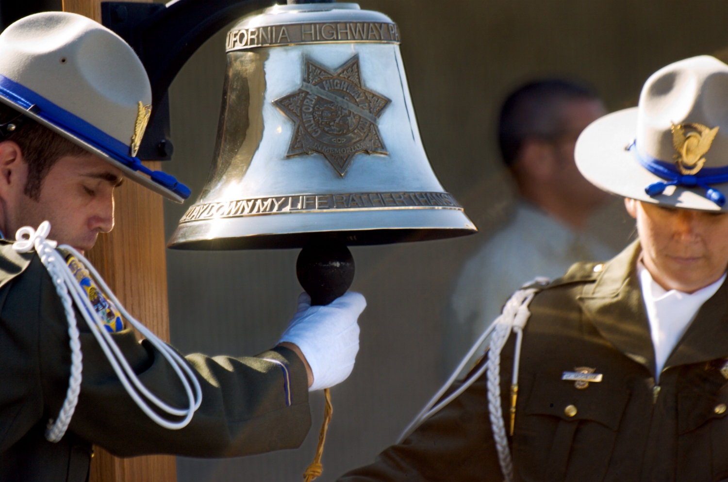 CHP Officers prepare to ring a bell during a ceremonial bell ringing at the CHP Academy in West Sacramento on Wednesday August 1, 2007. The ceremony was for Officer Douglas Russell who was killed in the line of duty in July.