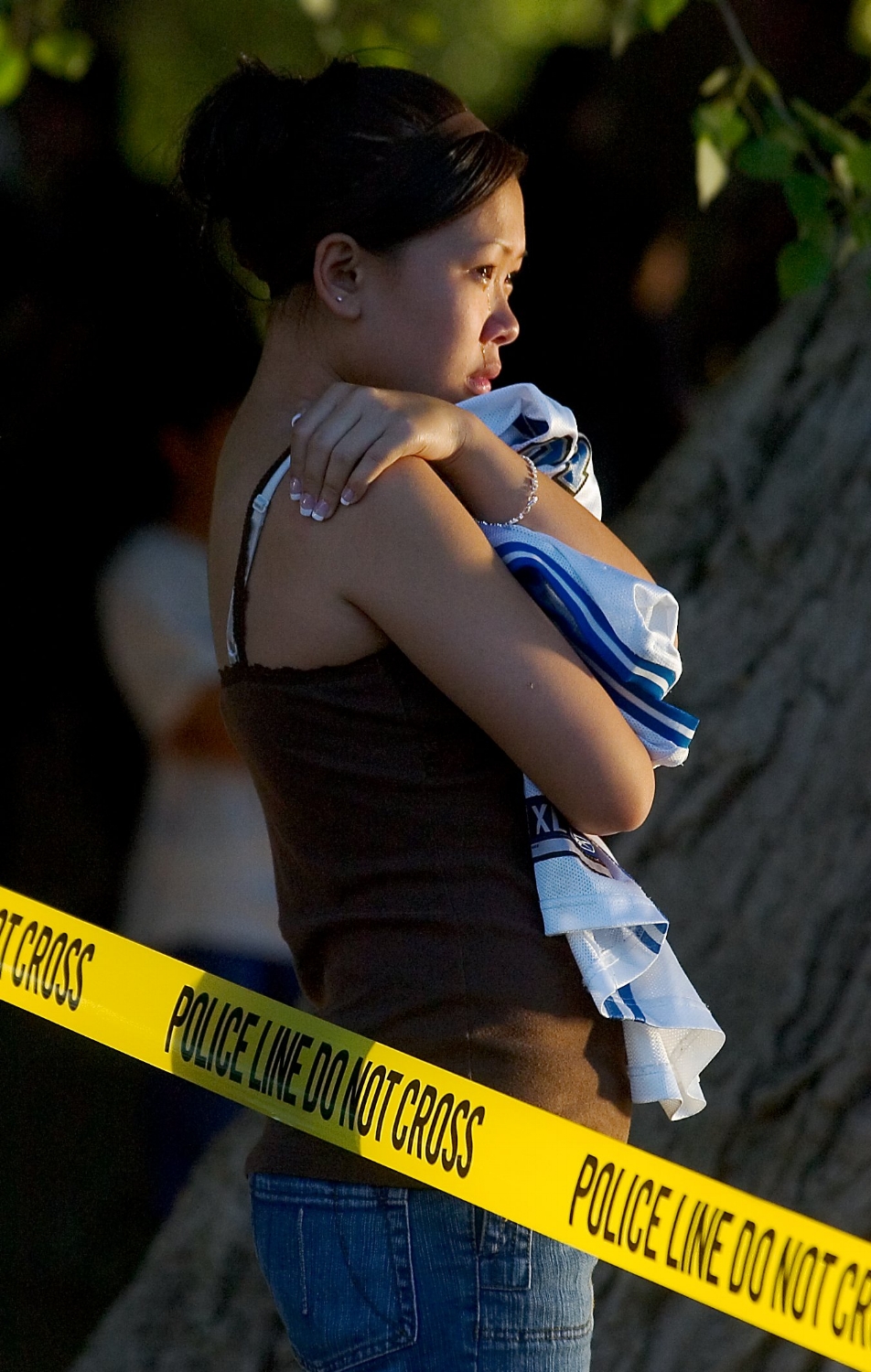  Julie Saeteurn 13, cries while she waits for law enforcement divers to recover the body of her boyfriend Jimmy Saeteurn from the river at Discovery Park in Sacramento on Thursday May 18, 2006. 