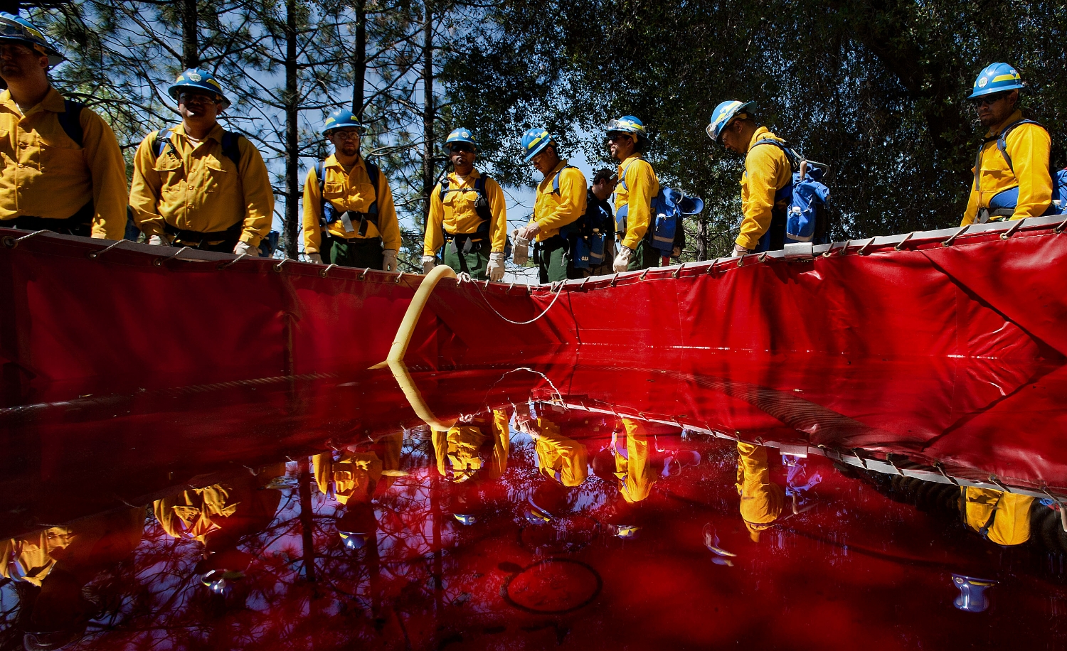 Firefighters line up around a makeshift water tank during a training exercise at the California Conservation Corps facilities in Auburn on Wednesday, May 9, 2012.