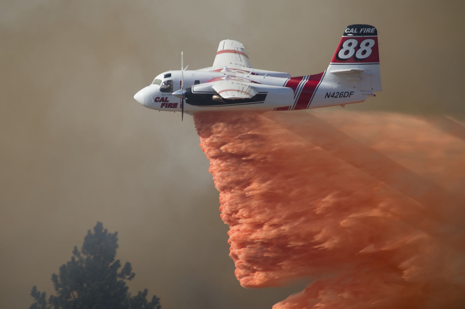  A Cal Fire aircraft drops fire retardant on a wild land fire burning near the Story winery in Plymouth, CA on Friday, July 25, 2014. 