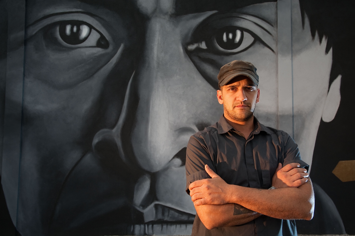  Mural artist Alex Forster stands in front of his artwork at 24th Street and Broadway in Sacramento on Monday, April18, 2011. 