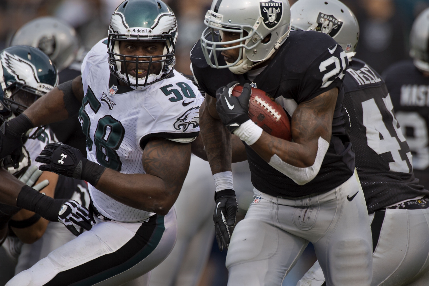  Raiders running back Darren McFadden (20) runs past Eagles outside linebacker Trent Cole (58) during the game between the Oakland Raiders and the Philadelphia Eagles at O.co Coliseum in Oakland on Sunday, November 3, 2013. 