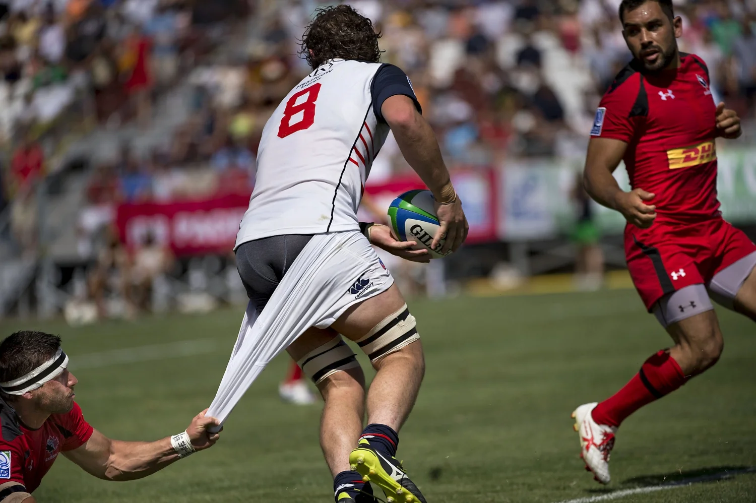 Men's Eagles Danny Barrett (8) is nearly tackled by Rugby Canada James Pritchard (15), left, during a rugby match between the USA Men's Eagles and Rugby Canada at Bonney Field in Sacramento on Saturday, June 21, 2014.